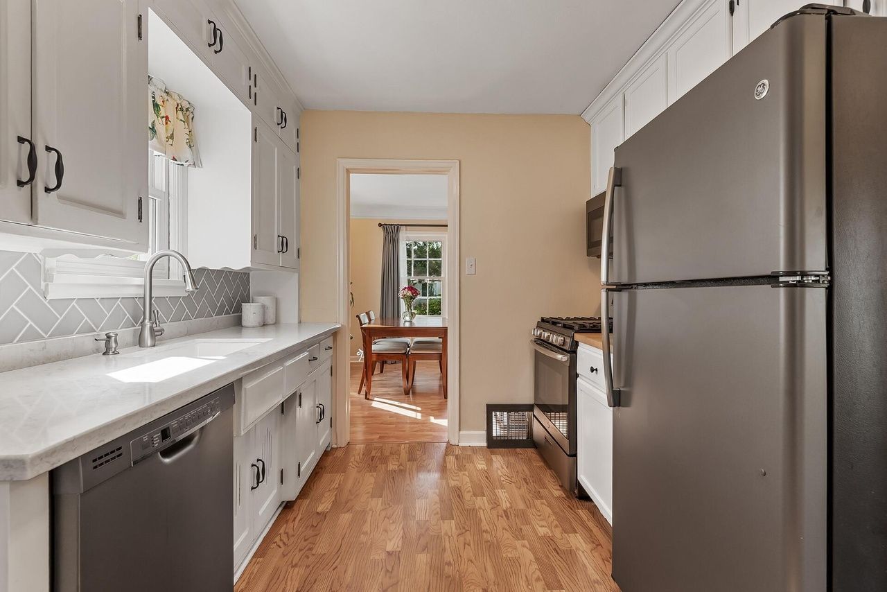 galley kitchen with granite and butcher block counters, plus updated appliances