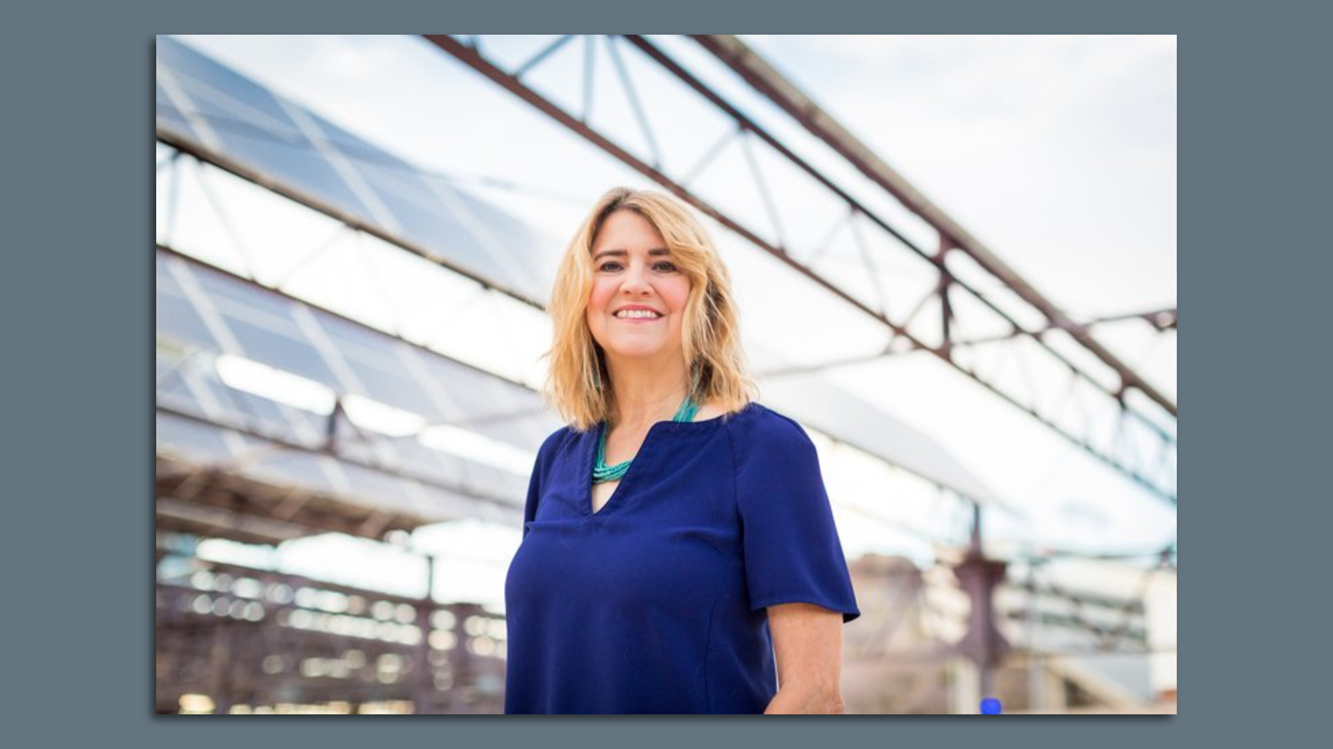 A woman smiles at the camera. 