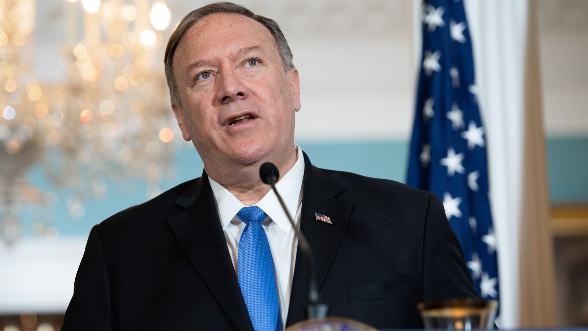Mike Pompeo speaking at a lectern in front of an American flag
