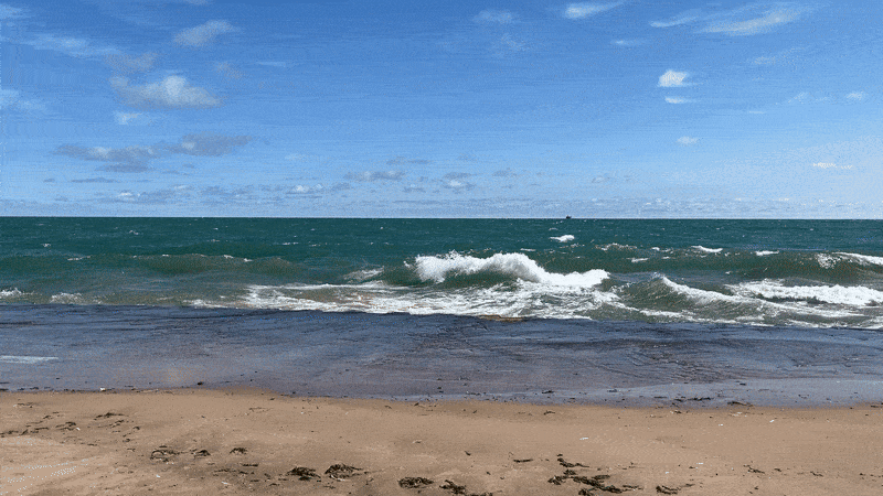 A gif of Lake Michigan waves crashing against the beach