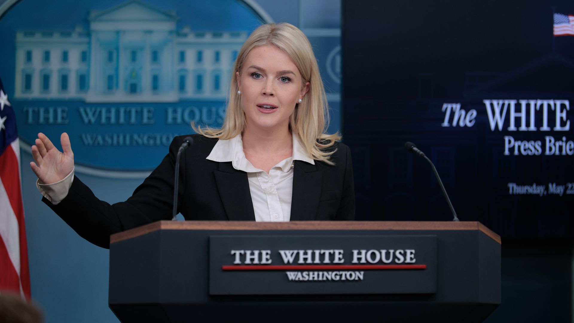 Karoline Leavitt gestures as she speaks at a White House press briefing from behind a lectern.