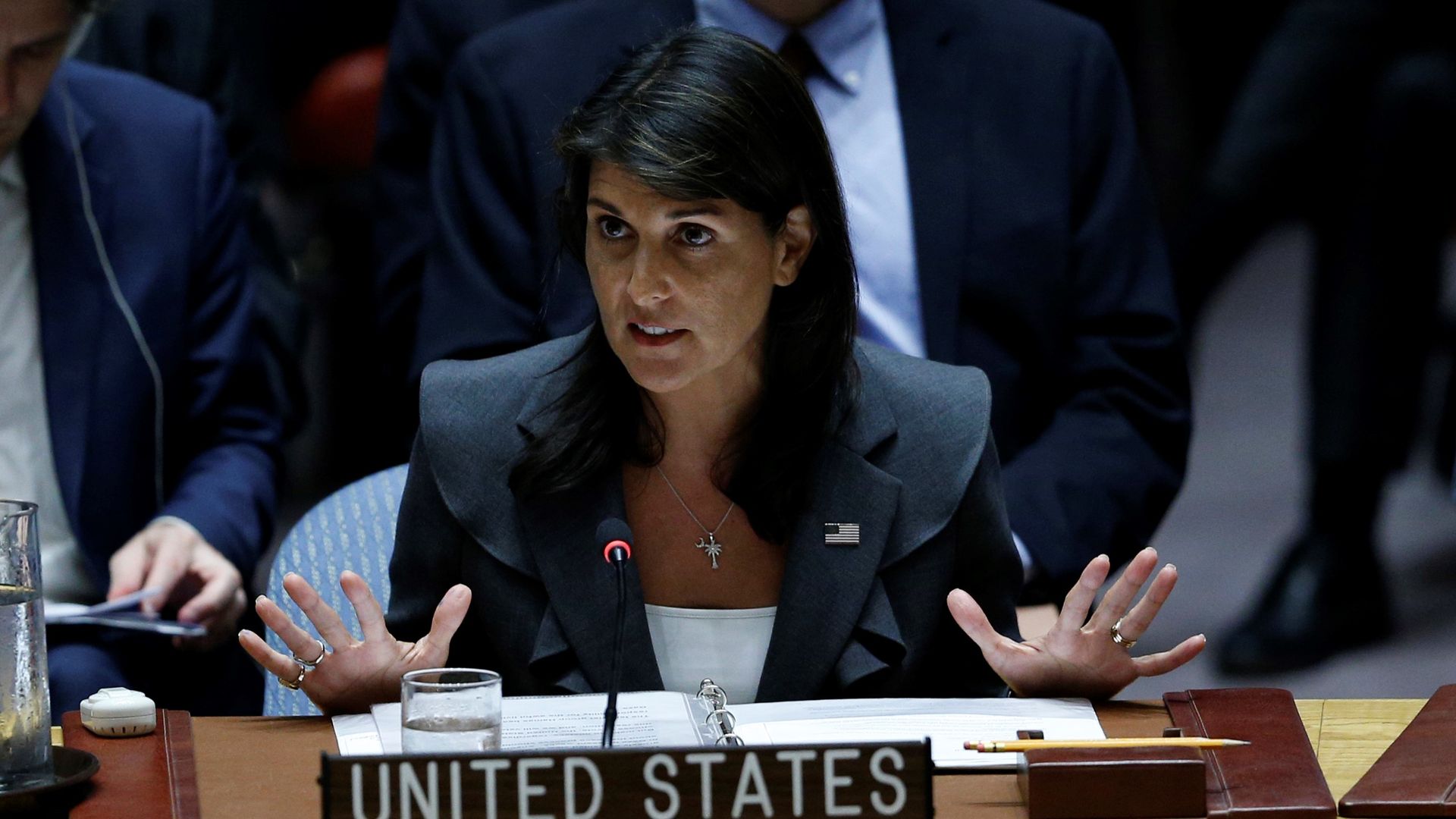 Nikki Haley puts her hands up while speaking behind the United States podium during a U.N. meeting