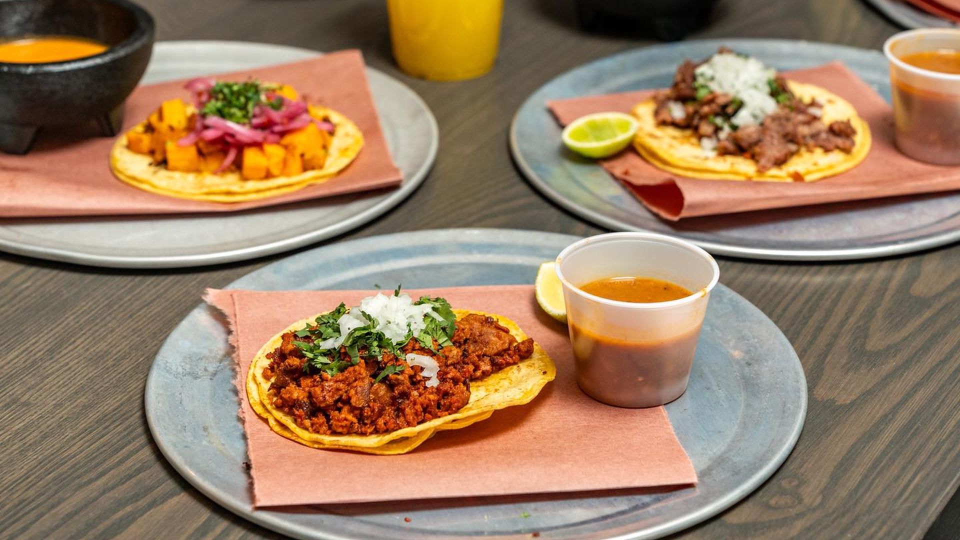 Three tacos on Silver platters