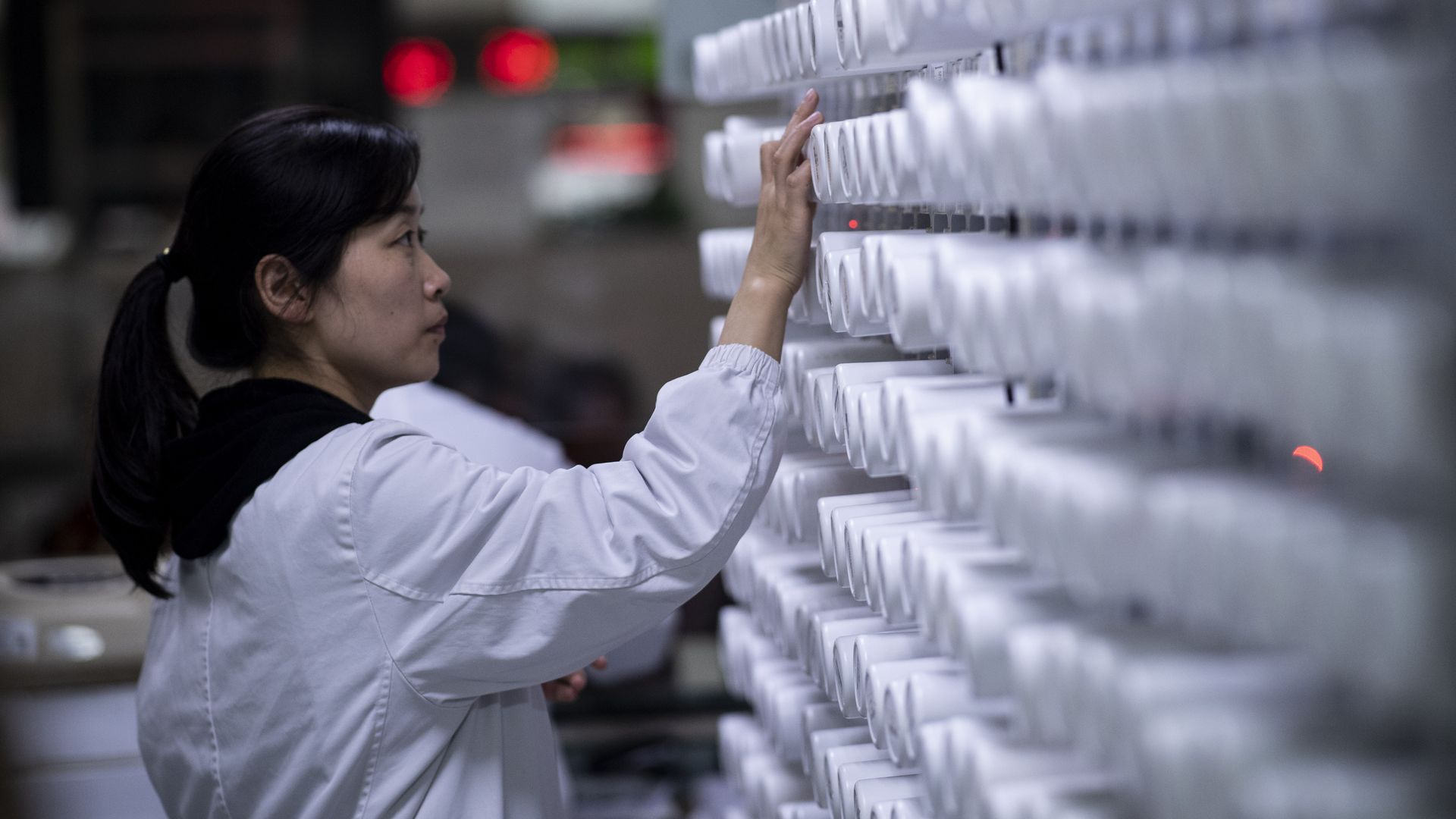 a woman sorting medicine in the pharmacy of the Yueyang Hospital, part of the Shanghai University of Traditional Chinese Medicine