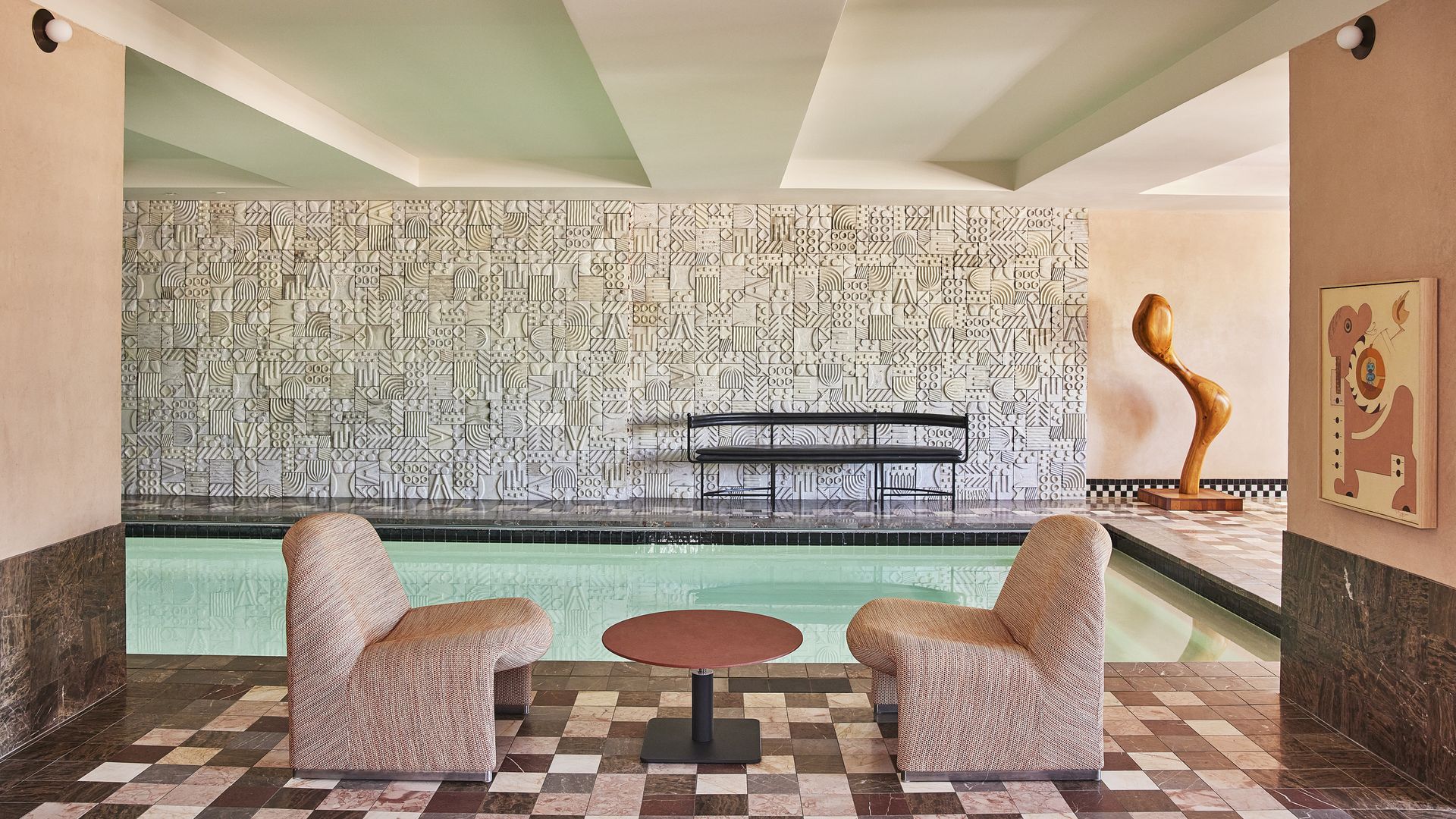 Two chairs alongside an indoor pool