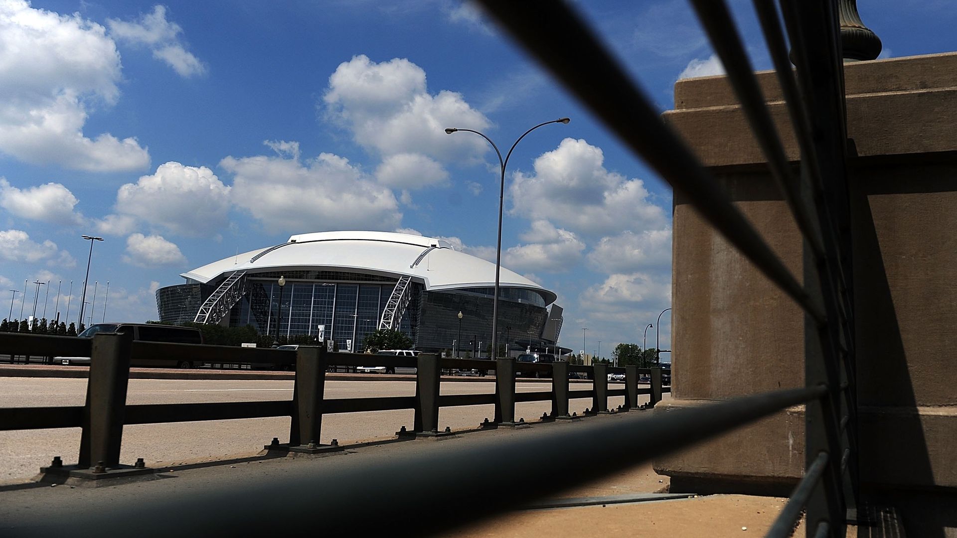 A stadium in the background, with railings in the foreground
