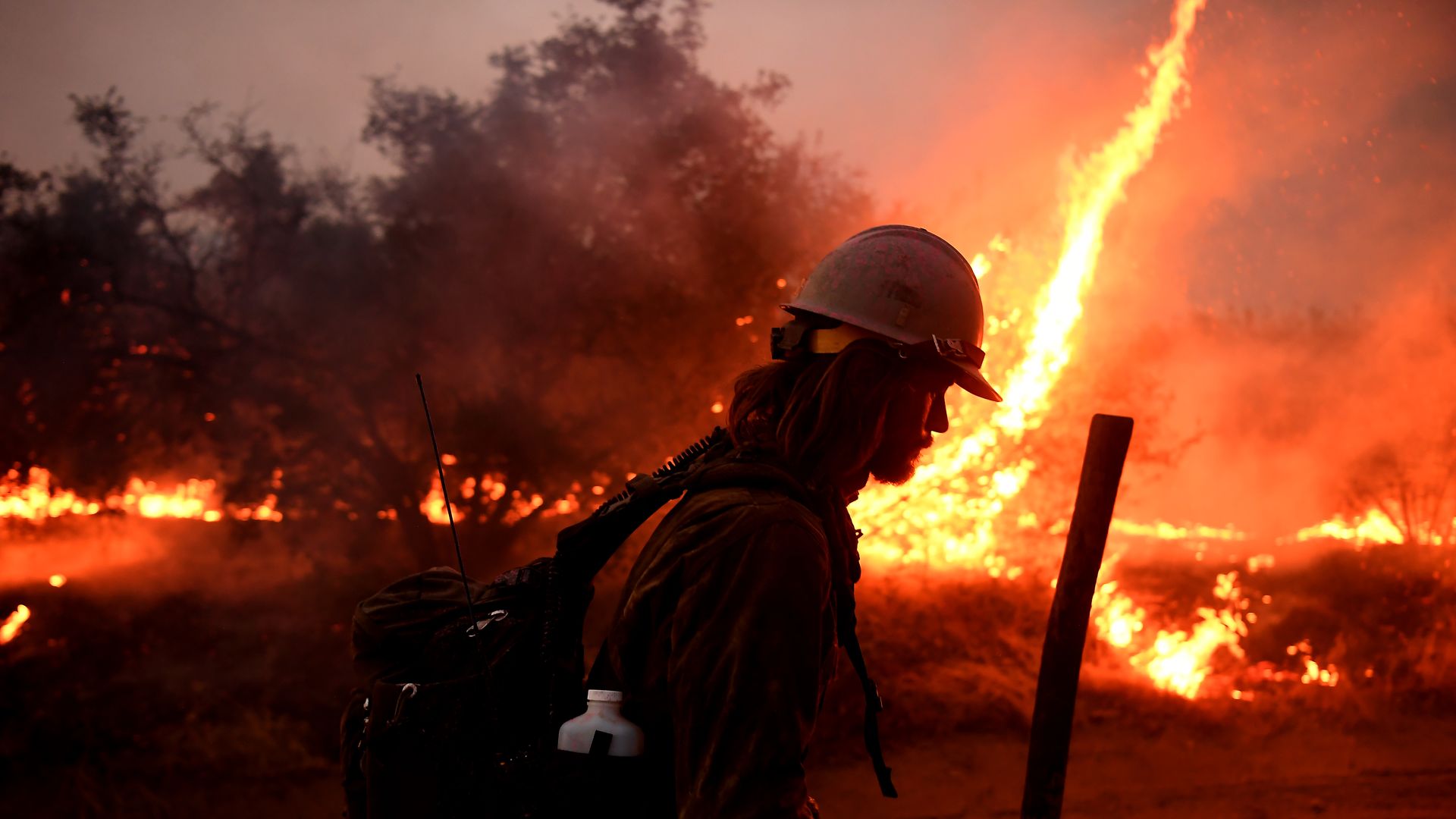 A firefighter helps to set bck fires as the El dorado Fire approaches in Tucaipa, California, in September.