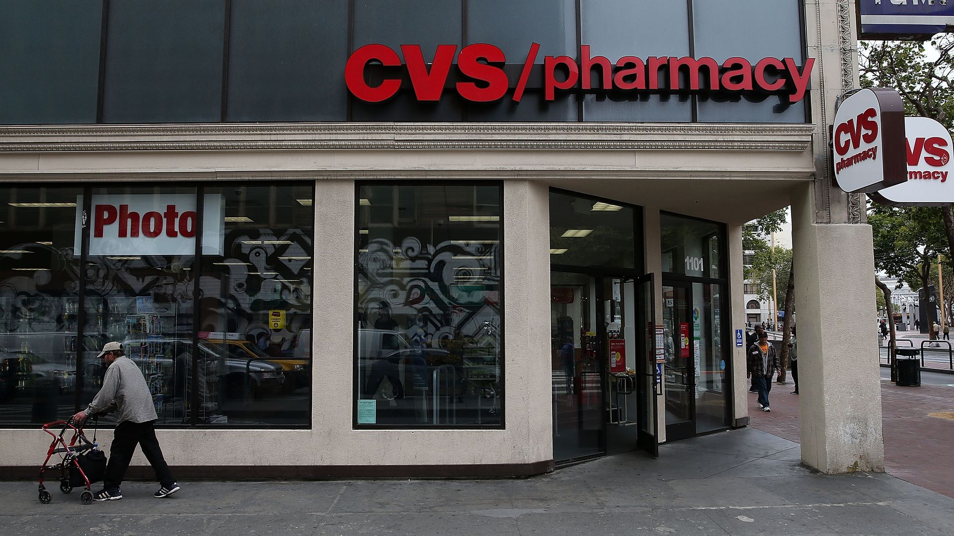 A pedestrian walks by a CVS store.