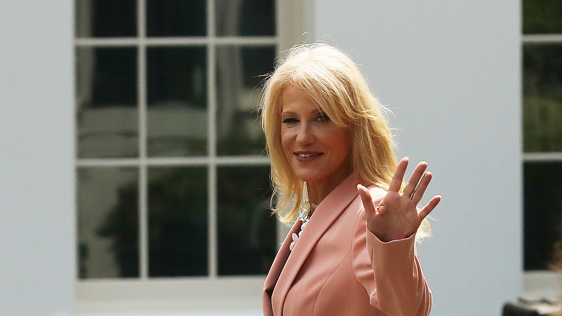 White House Counselor to the President Kellyanne Conway returns to the West Wing after talking to reporters outside the White House on August 21