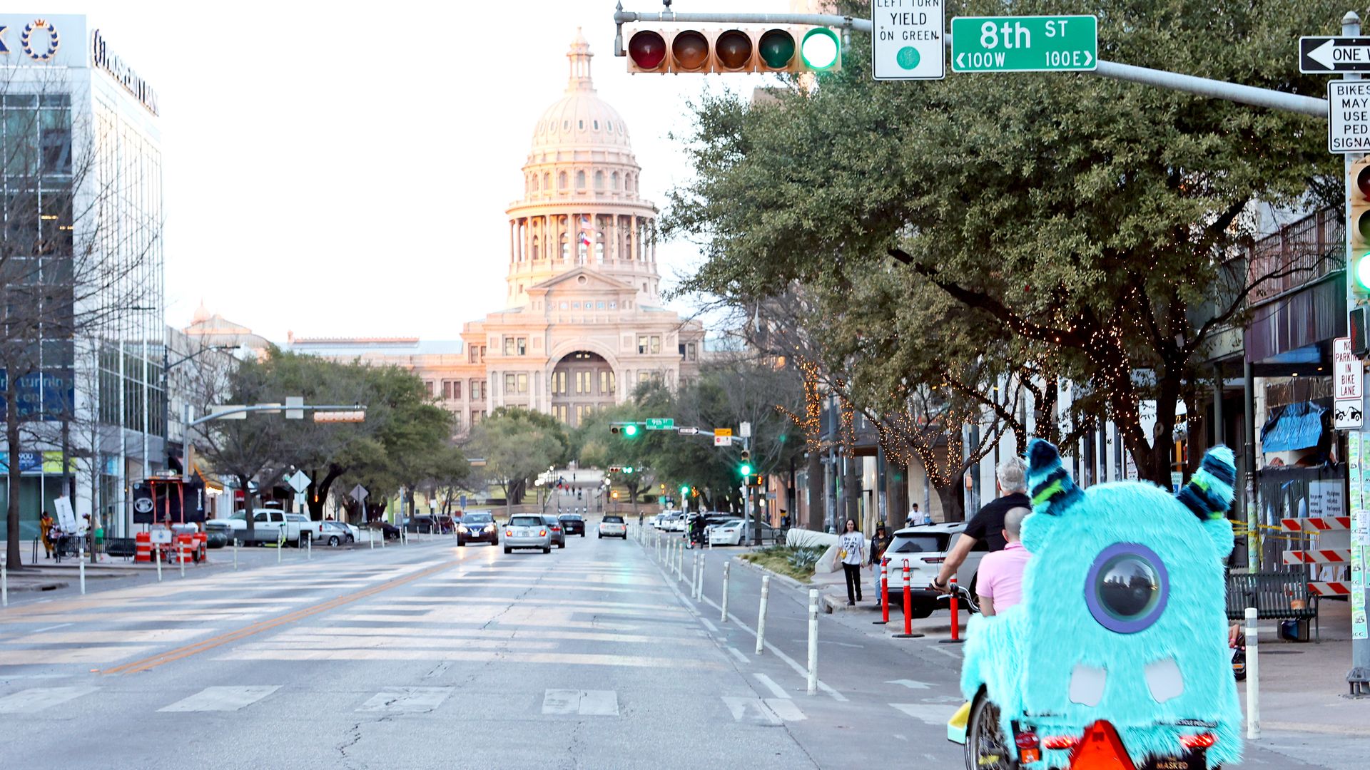 A view of the Capitol, with a traffic light in the foreground.