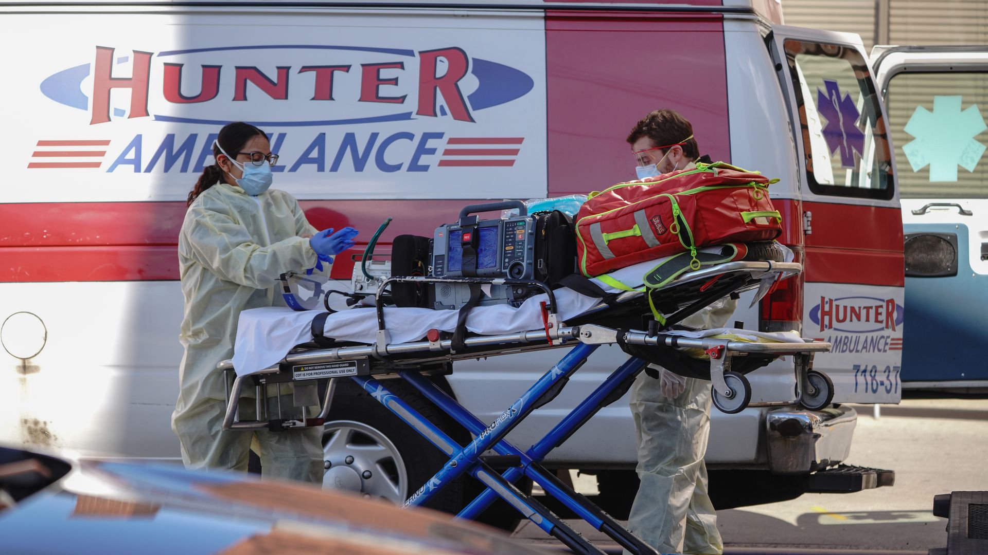 Medical workers preparing for a patient in a nursing home in Queens, New York.