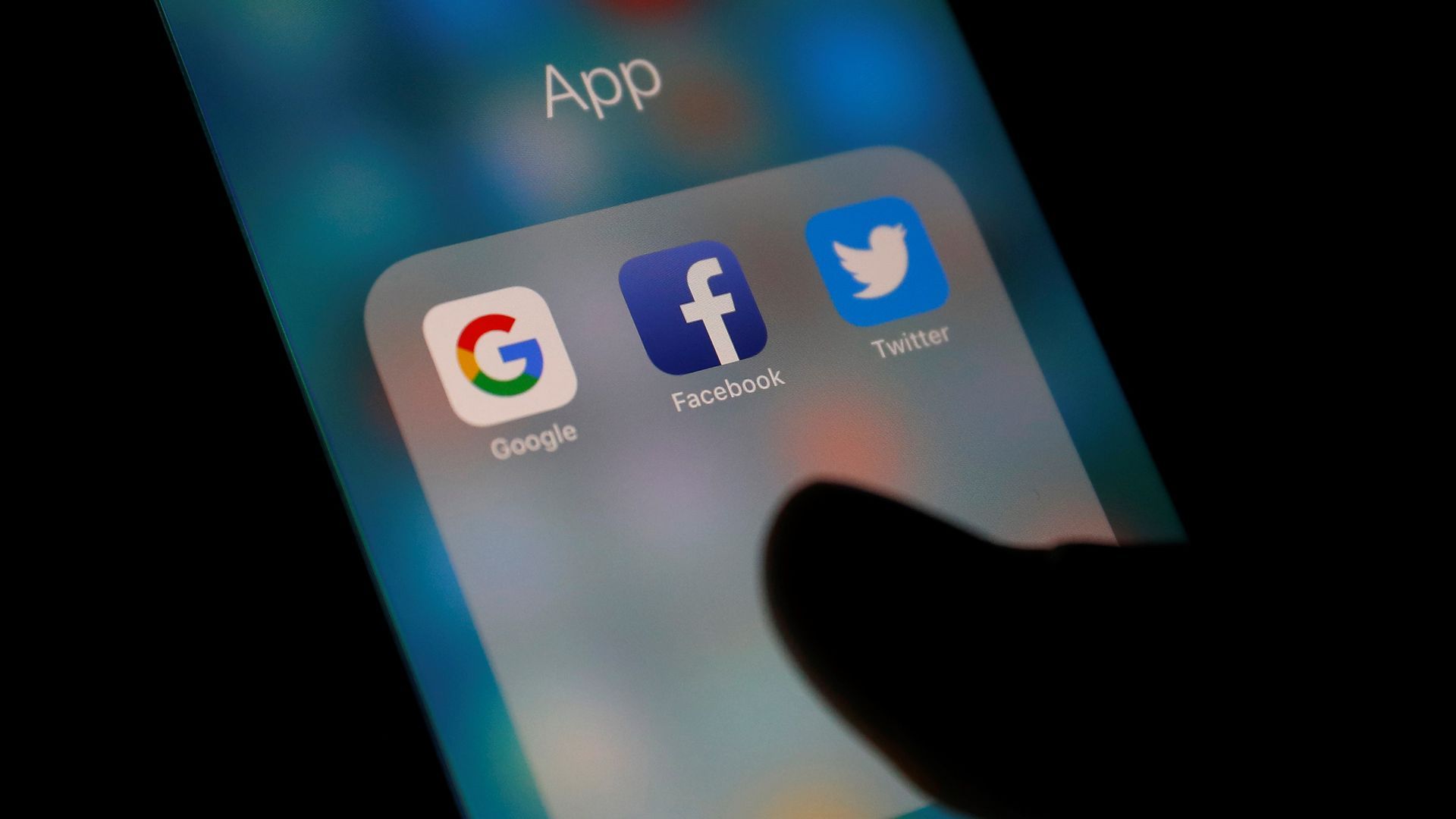 Facebook, Google and Twitter icons on a smartphone