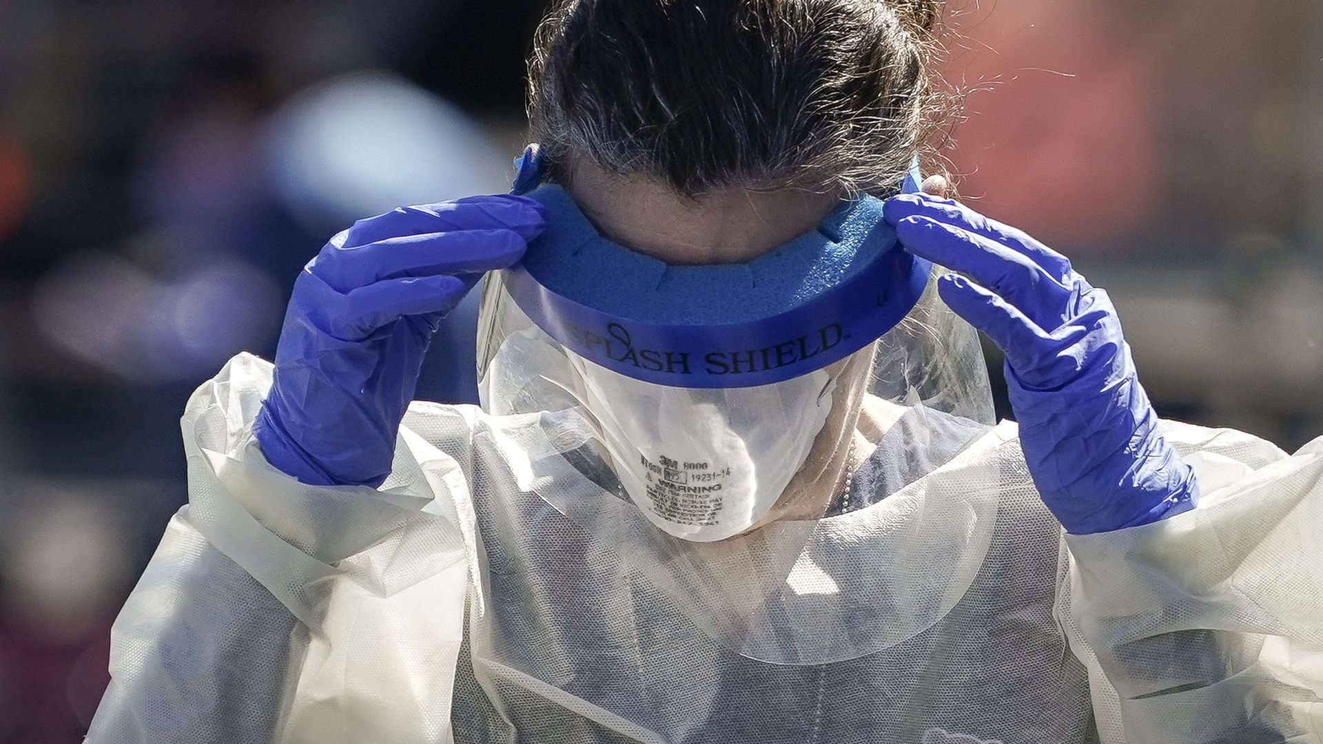 A medical professional from Children's National Hospital works at a coronavirus drive-thru testing site