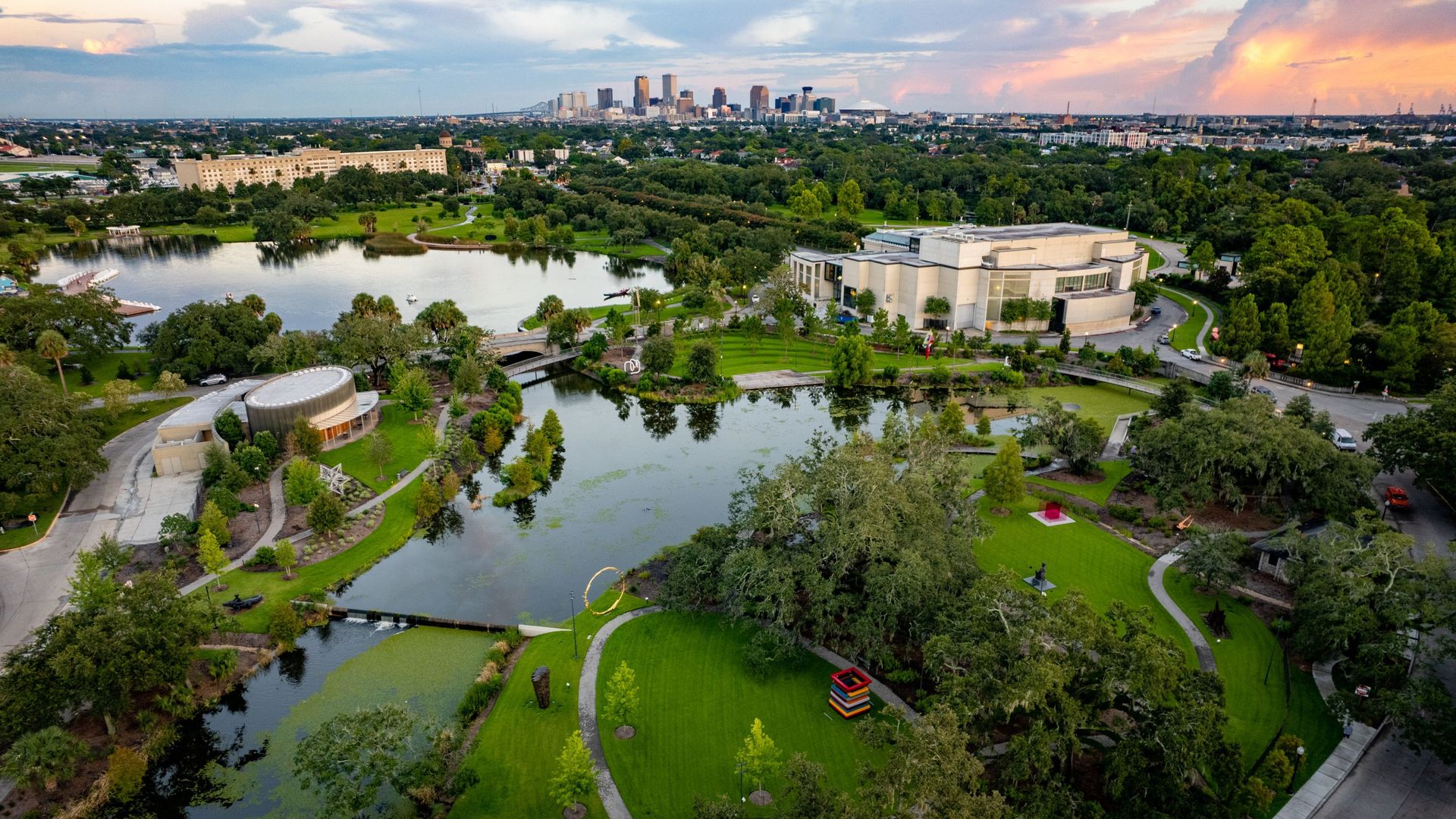 Photo shows New Orleans City Park with the skyline in the background.
