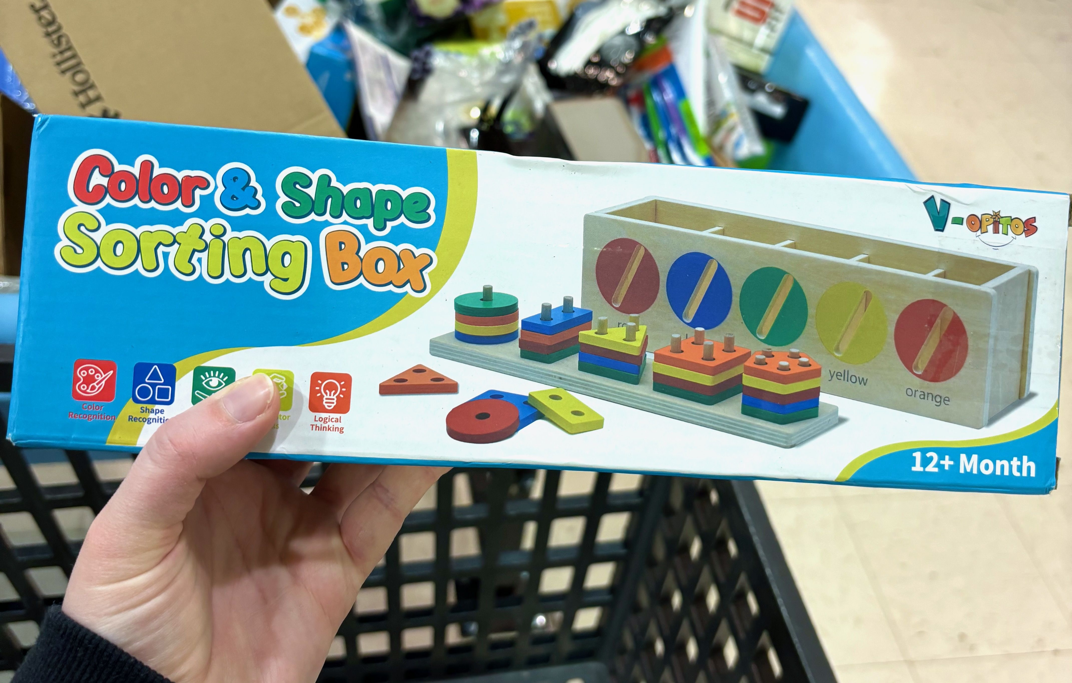 A "color and shapes sorting box" toy for kids ages 12 months and up, inside the box