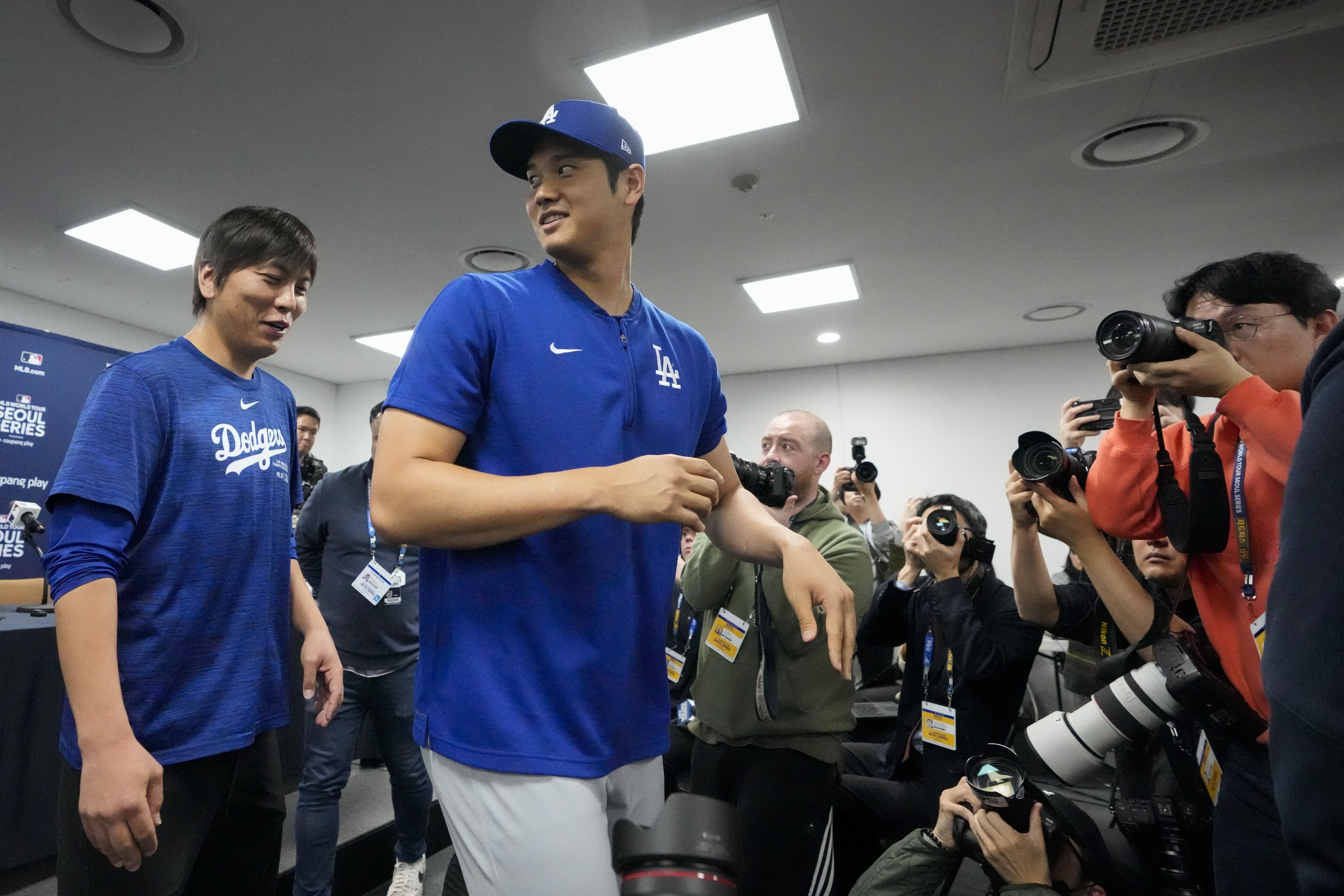 Shohei Ohtani and interpreter Ippei Mizuhara (left) leave a press conference in South Korea last month.