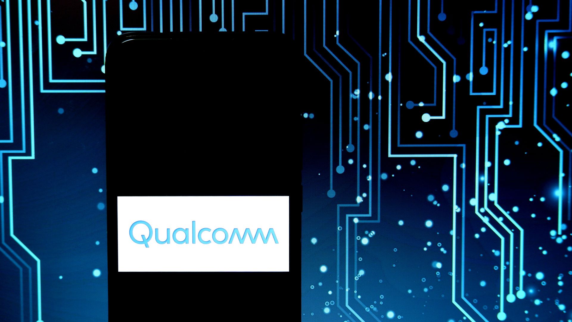 Photo illustration of microcircuits around the Qualcomm logo.