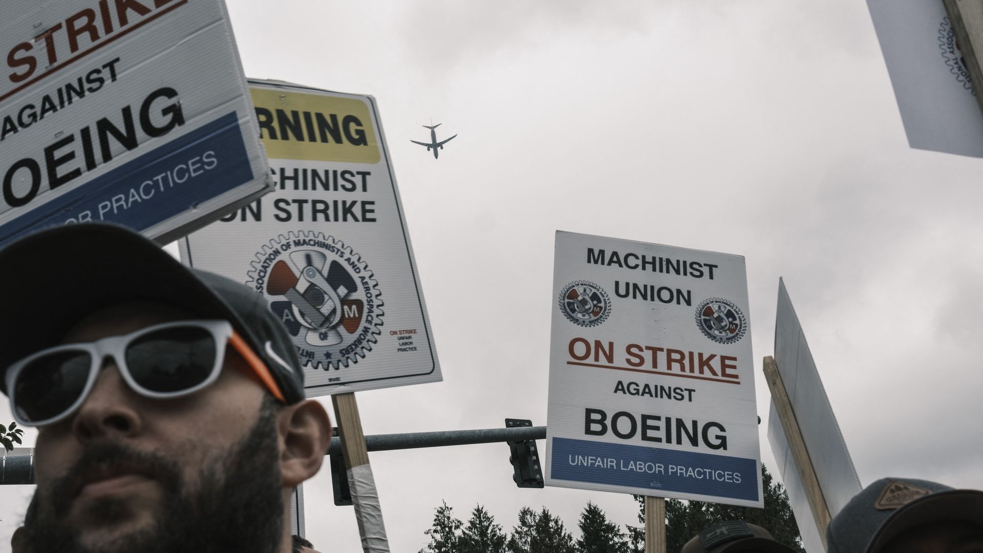 Picketing workers hold strike signs