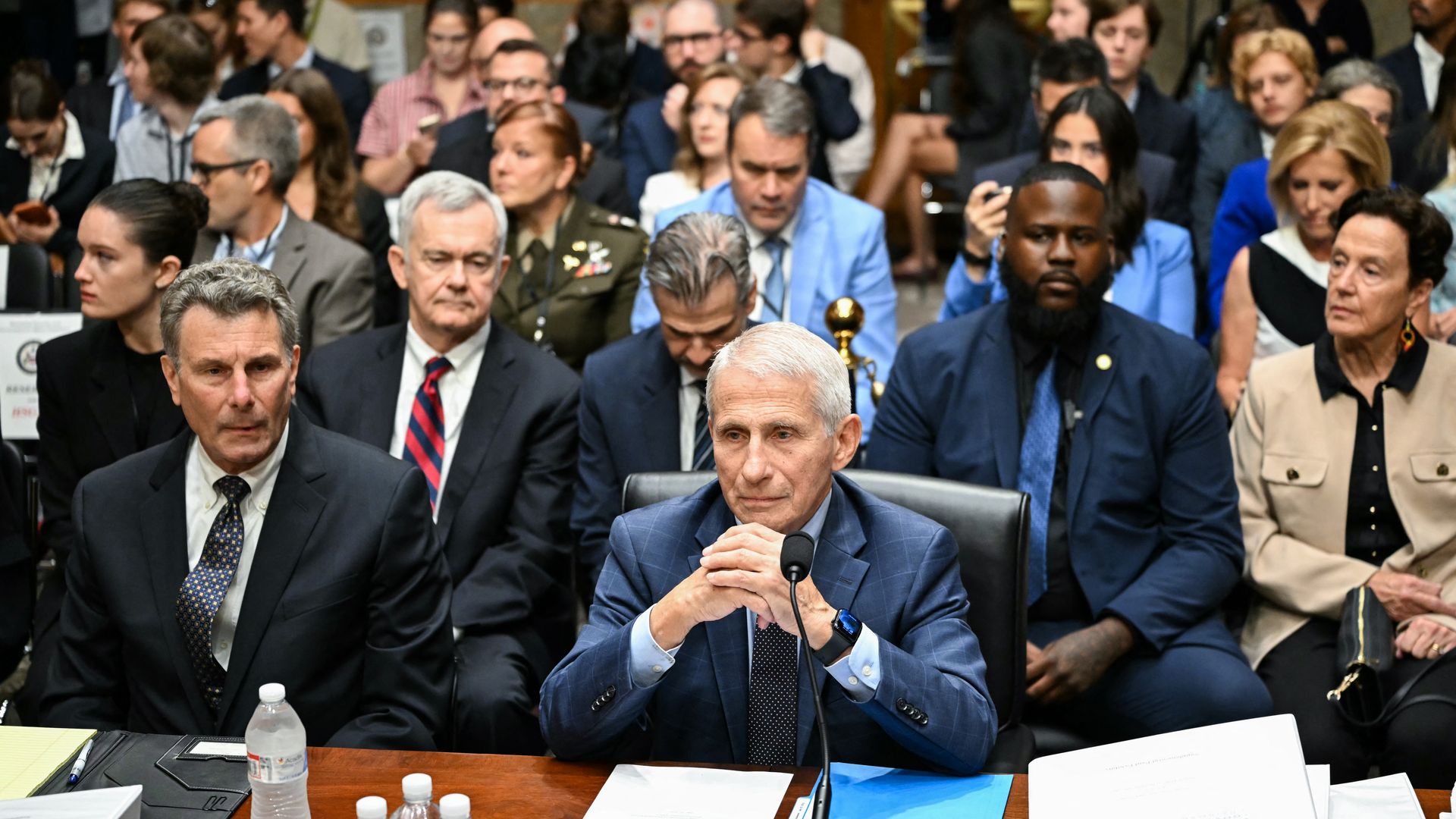 Anthony Fauci sits at a witness table at the start of a Senate committee hearing
