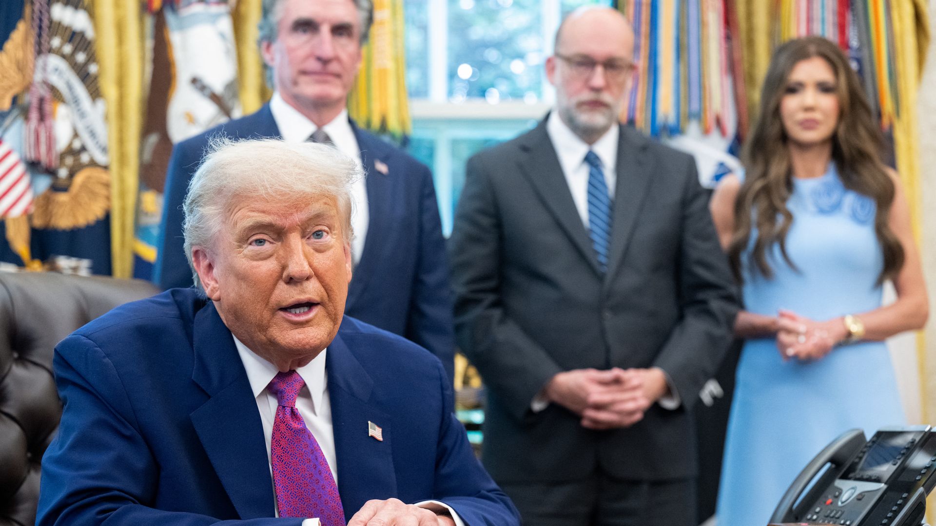 US President Donald Trump speaks about the upcoming wildfire and hurricane seasons, alongside Secretary of the Interior Doug Burgum (L), OMB Director Russell Vought (C) and Secretary of Homeland Security Kristi Noem (R) in the Oval Office of the White House in Washington, DC, on June 10, 2025.