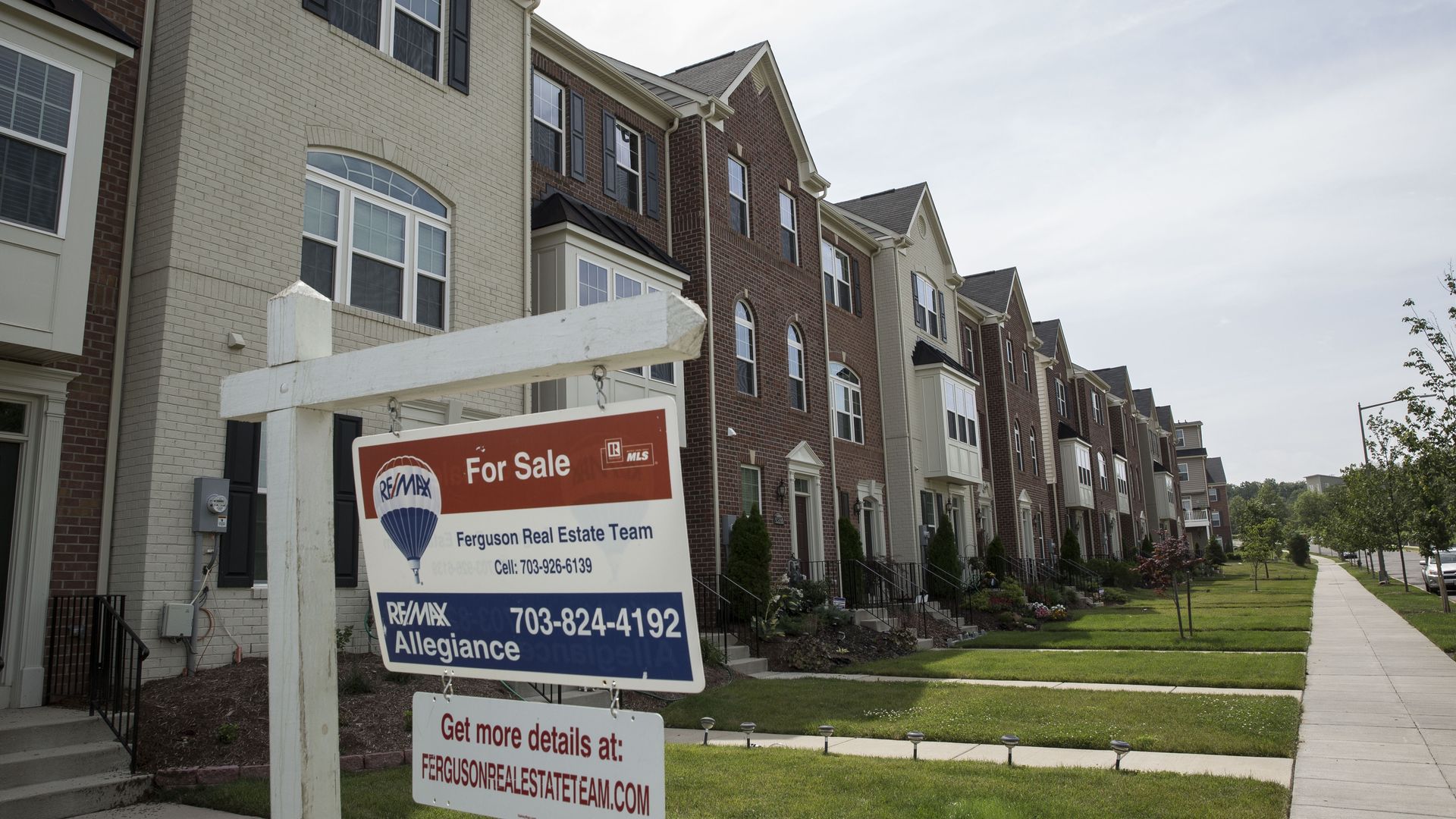 For sale signs in a row of town houses
