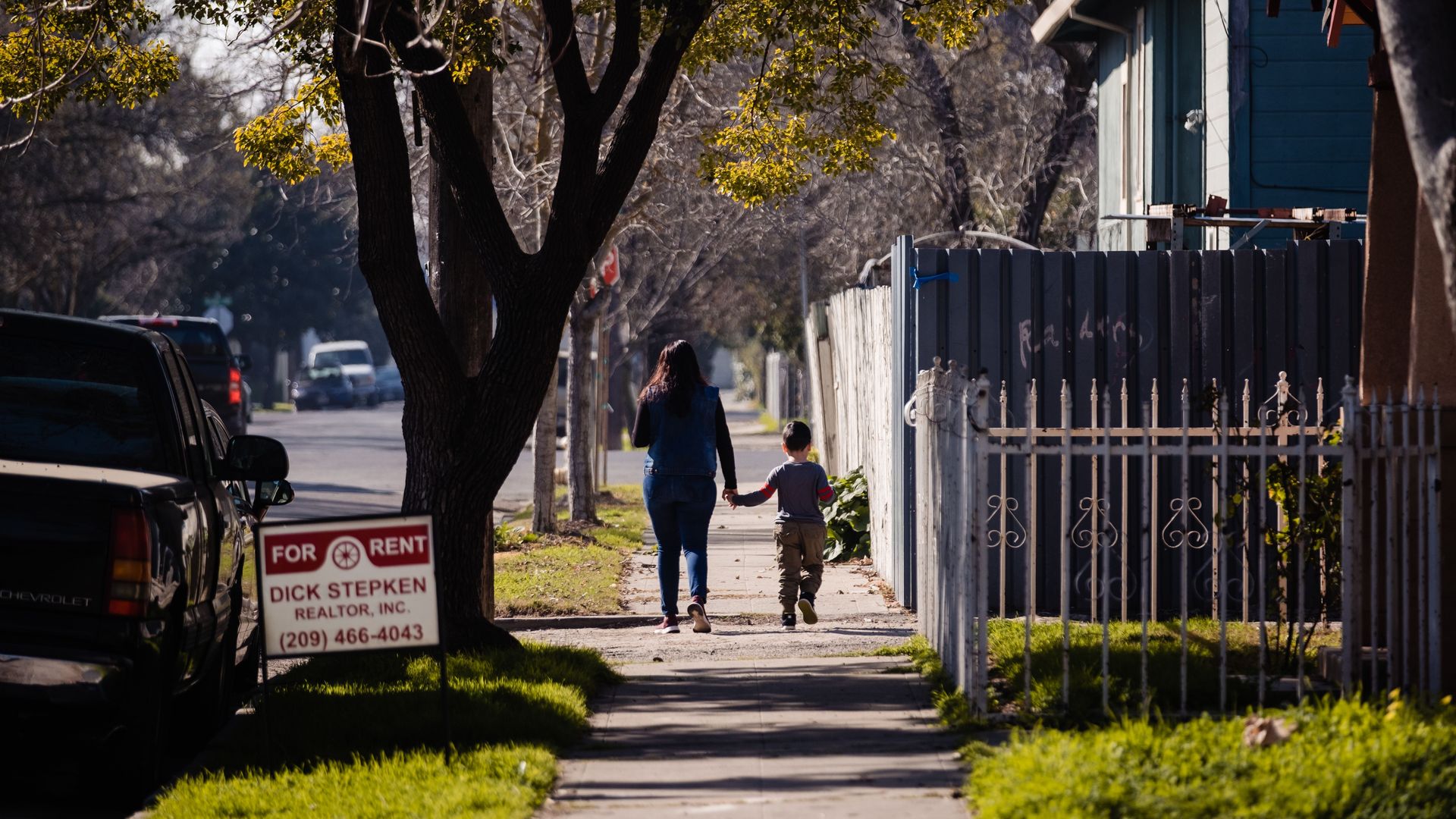 A mother and son walk in a Stockton, Calif., neighborhood