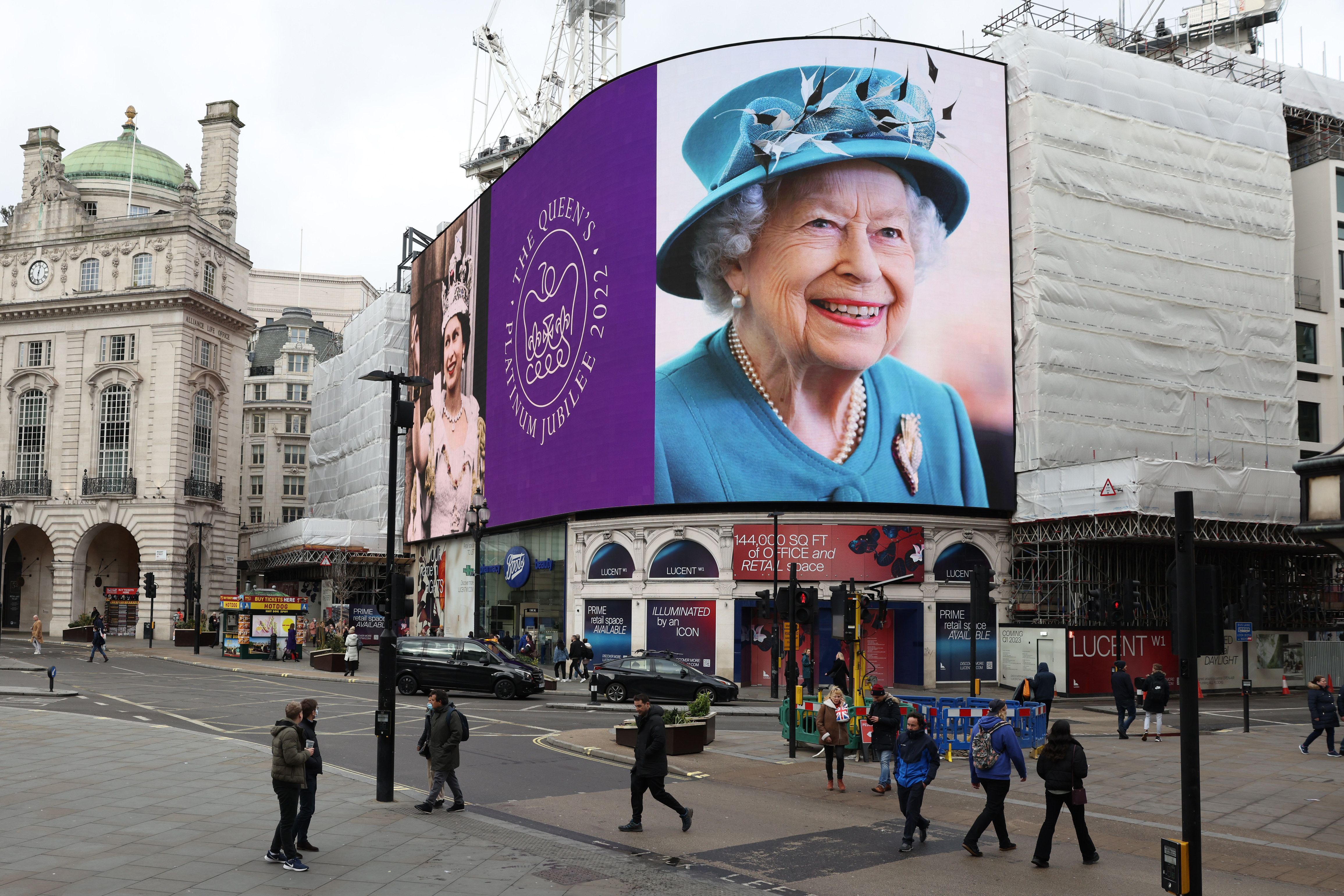 A portrait of Queen Elizabeth II is displayed on the large screen at Piccadilly Circus