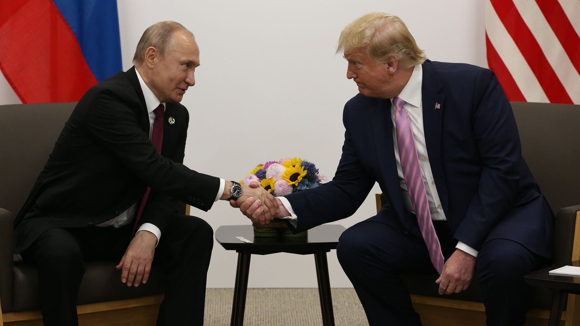 President Trump and Russian President Vladimir Putin shaking hands at the G20 Summit in Japan