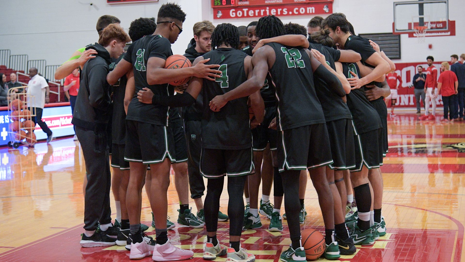 Dartmouth Big Green players huddle on the court prior to a college basketball game between the Dartmouth Big Green and the Boston University Terriers on December 13, 2022, at Case Gym in Boston, MA. 