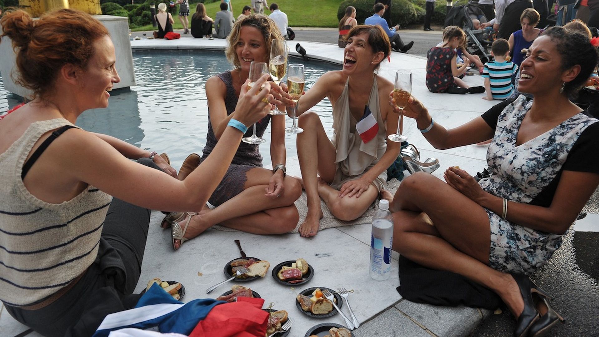 Four women toast Champagne on Bastille Day at the French Embassy