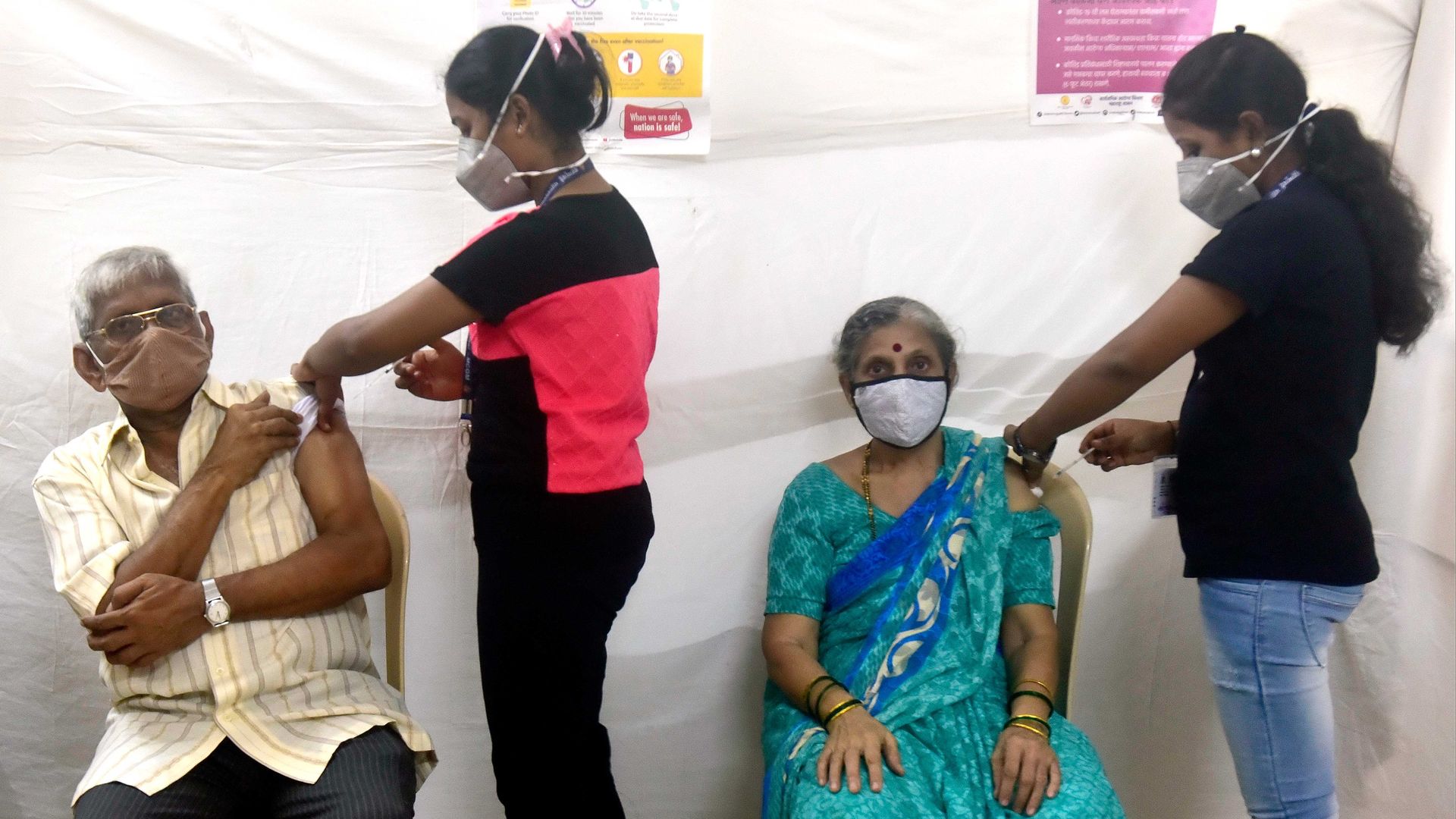 Beneficiaries receive COVID-19 vaccine during a vaccination drive at BPK Sahakari Vidya Mandir, on June 21, 2021 in Mumbai, India.