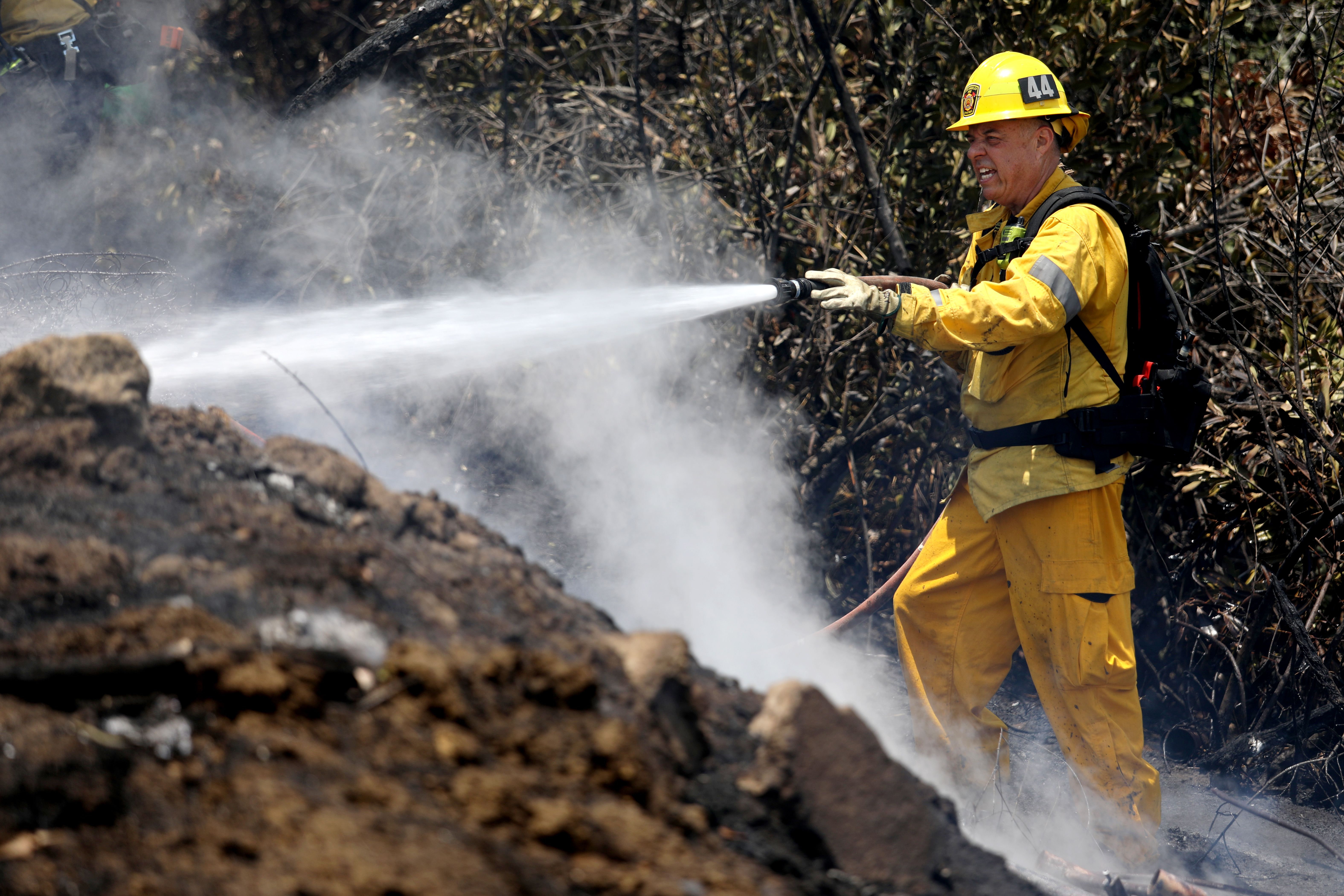 A firefighter responds to a brush fire in Los Angeles on June 16