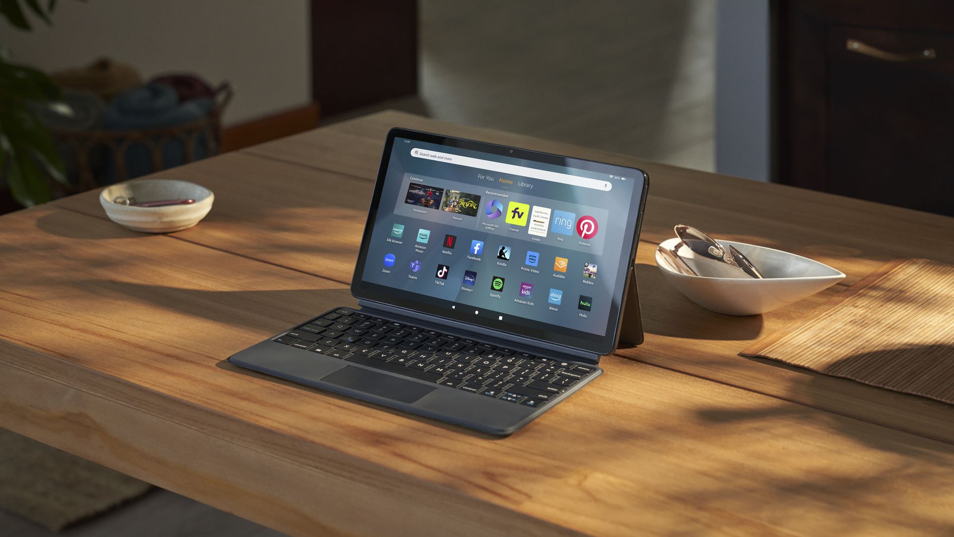A picture of Amazon's Fire 11 Max tablet, with keyboard case attached, on a kitchen table