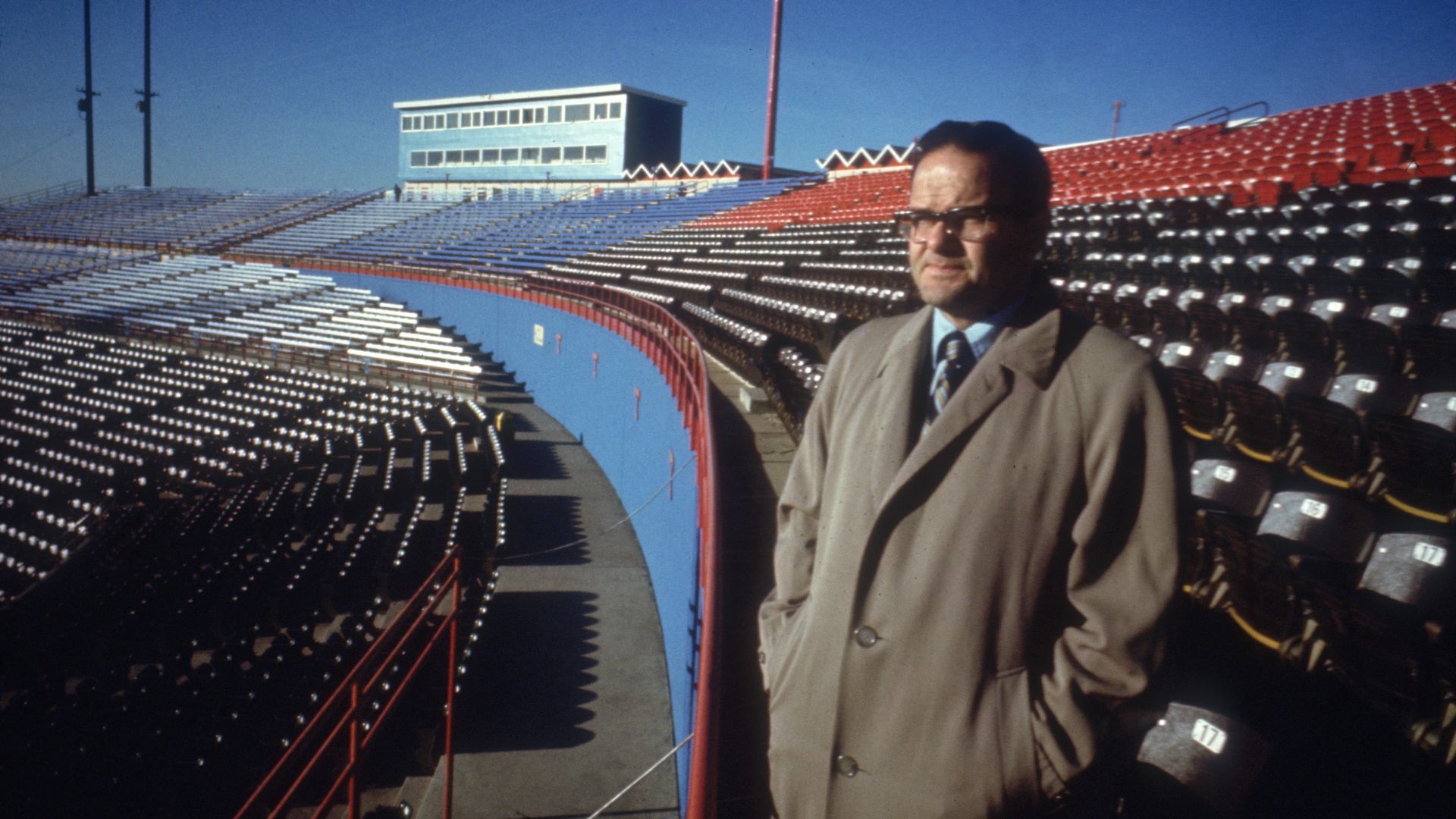 An archived photo of Lamar Hunt standing in an empty stadium in Kansas City in 1967