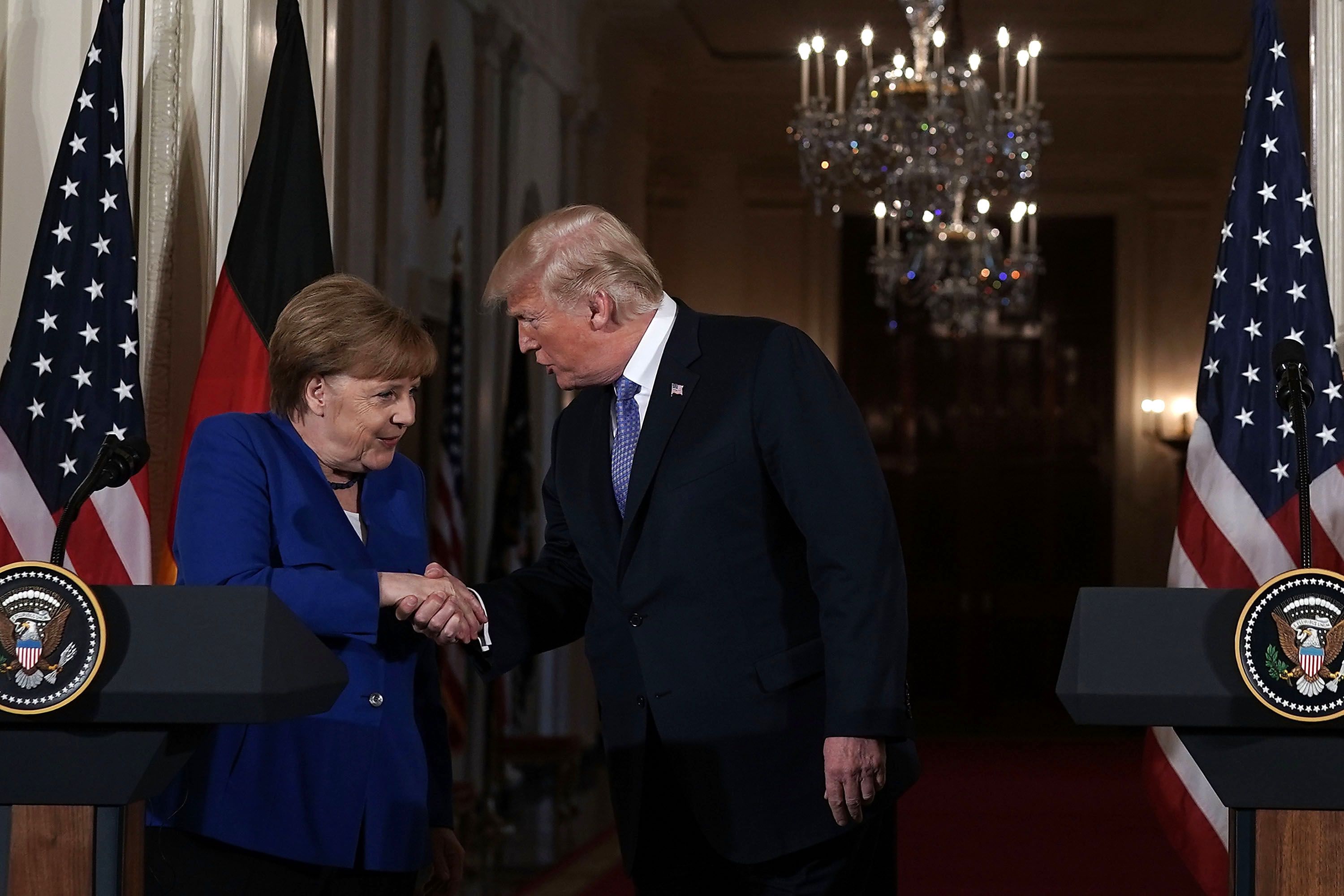 Trump and Merkel handshake.