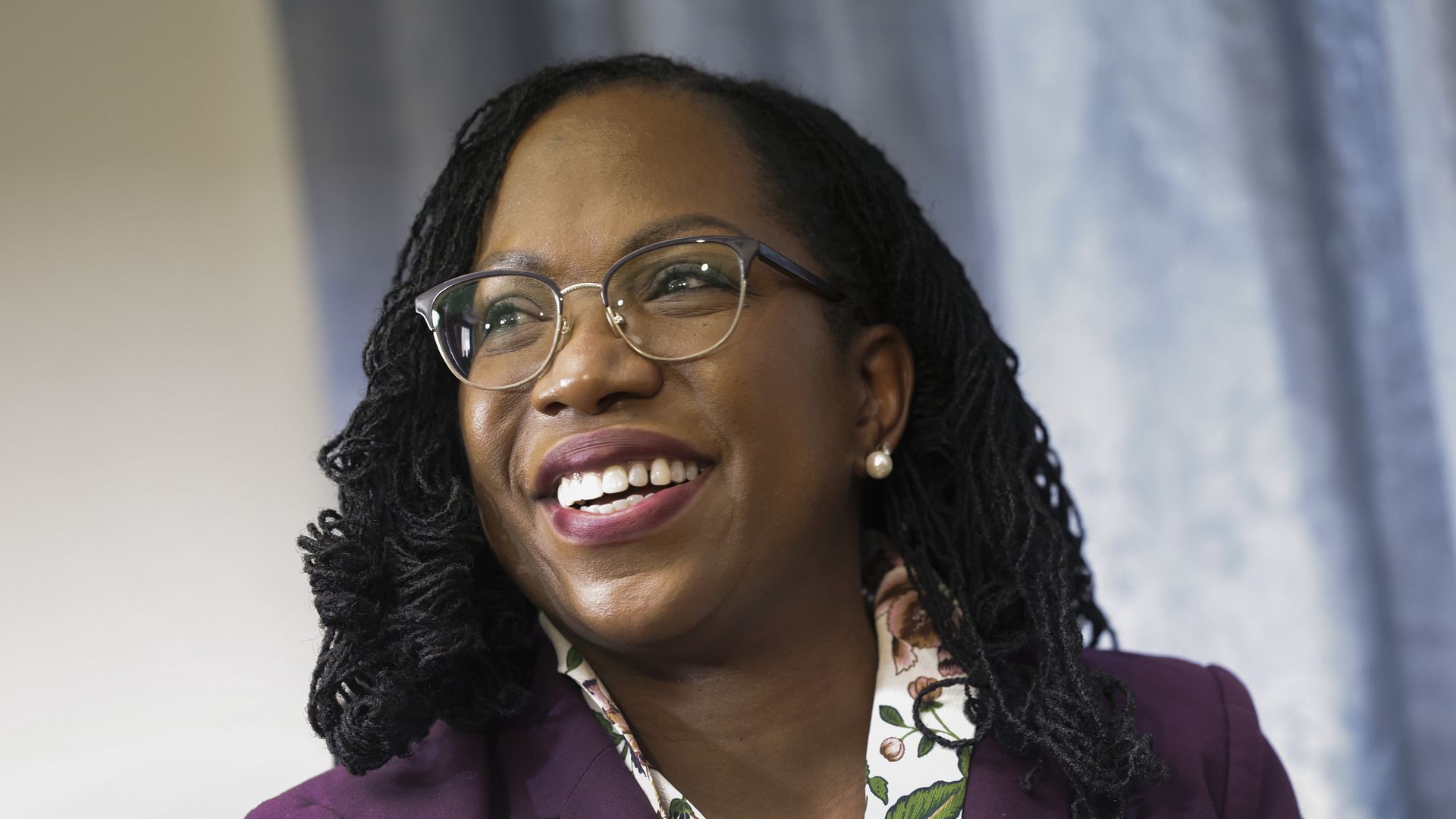 Photo of Ketanji Brown Jackson smiling to her right