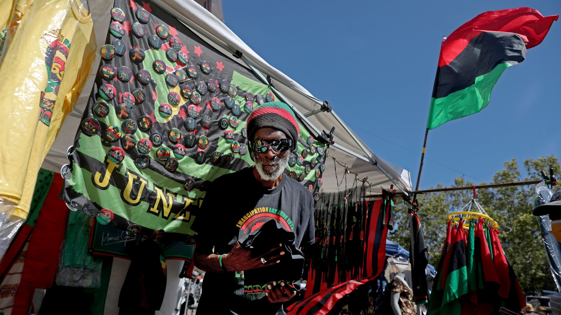 Michael Simpliss sells his wares at the Leimert Park Juneteenth Festival in Leimert Park Village on June 18, 2022 in Los Angeles.