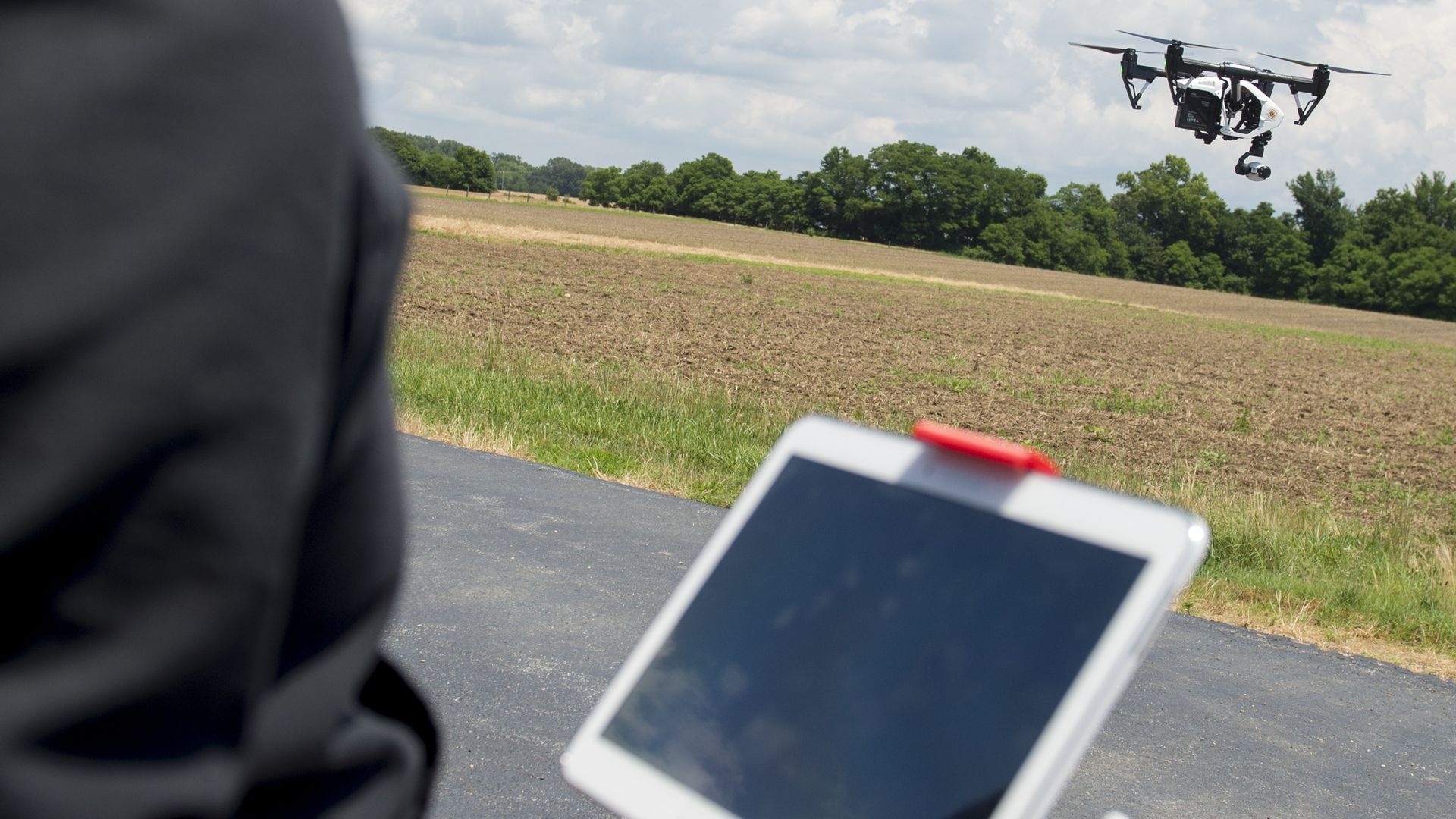 Photo of person using a drone outdoors