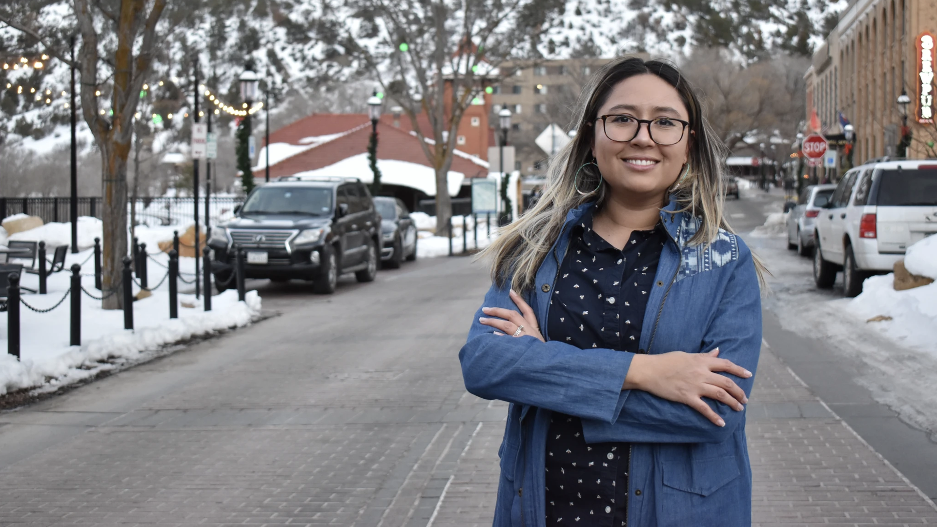 Elizabeth Velasco stands on a snowy street in downtown Aspen, Colorado.