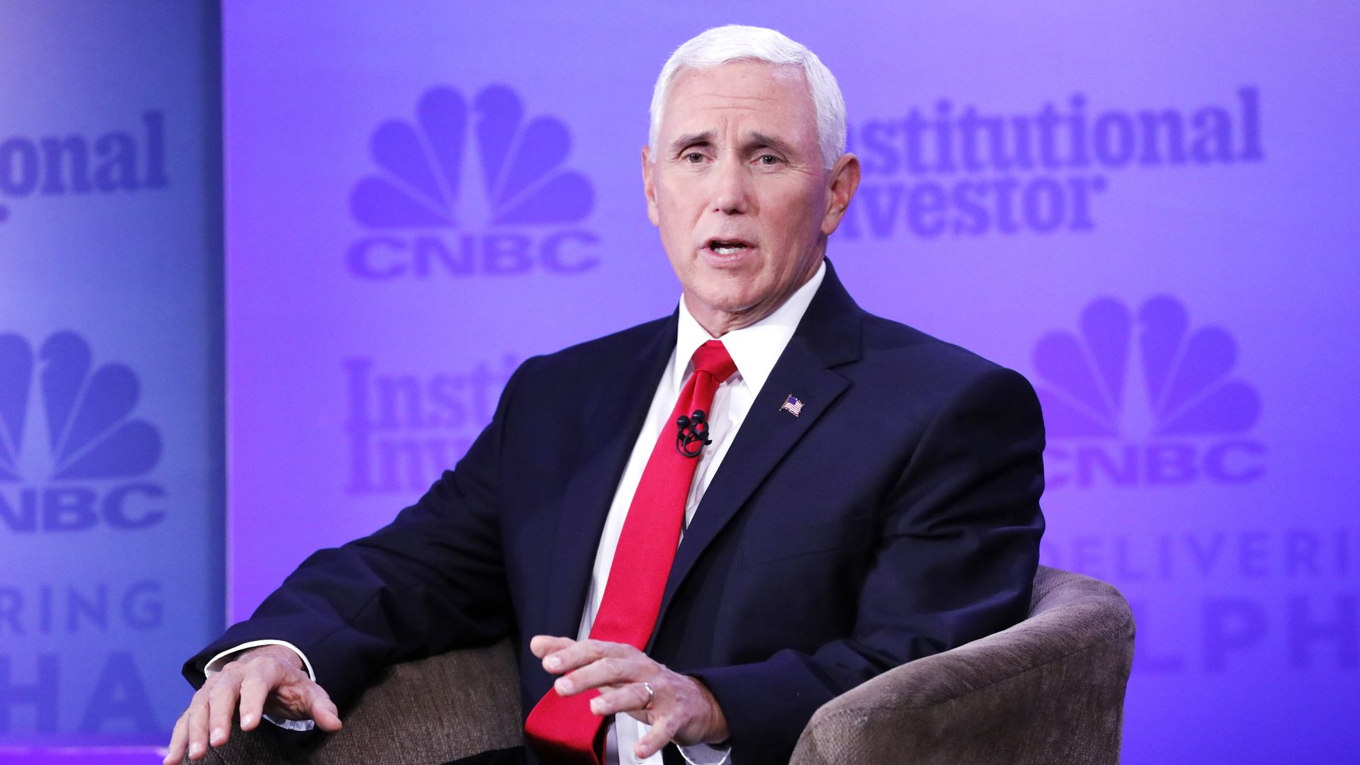 Pence sits in a chair. 