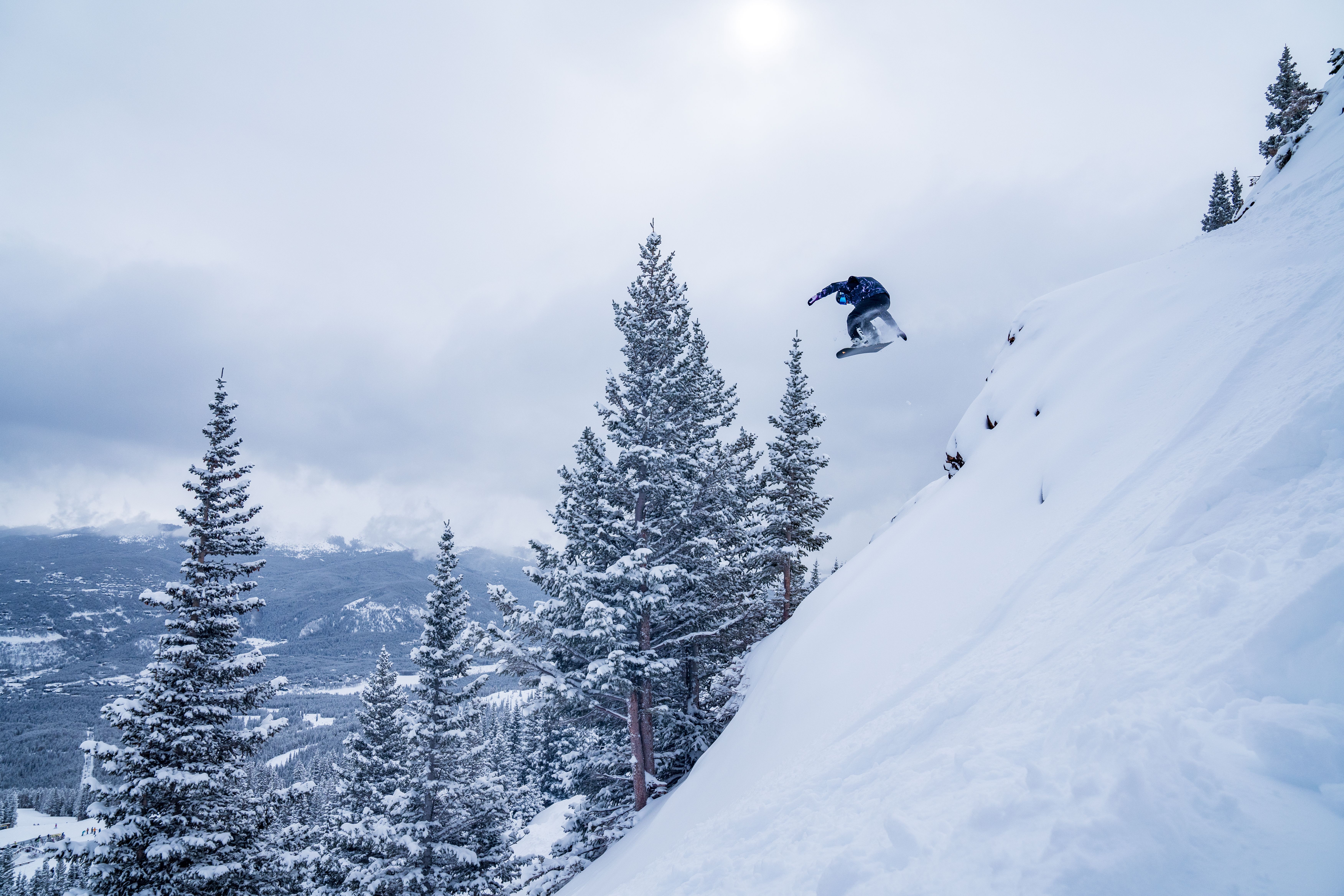 Snowboarder Jesse Orlean jumps off Kings Rock at Breckenridge ski resort. Photo courtesy of JP Douvalakis