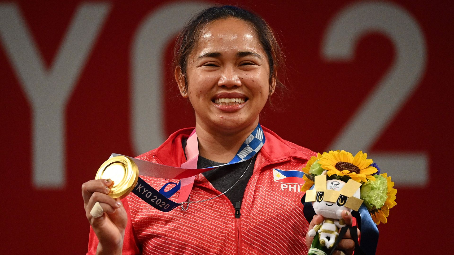 Gold medallist Philippines' Hidilyn Diaz stands on the podium 