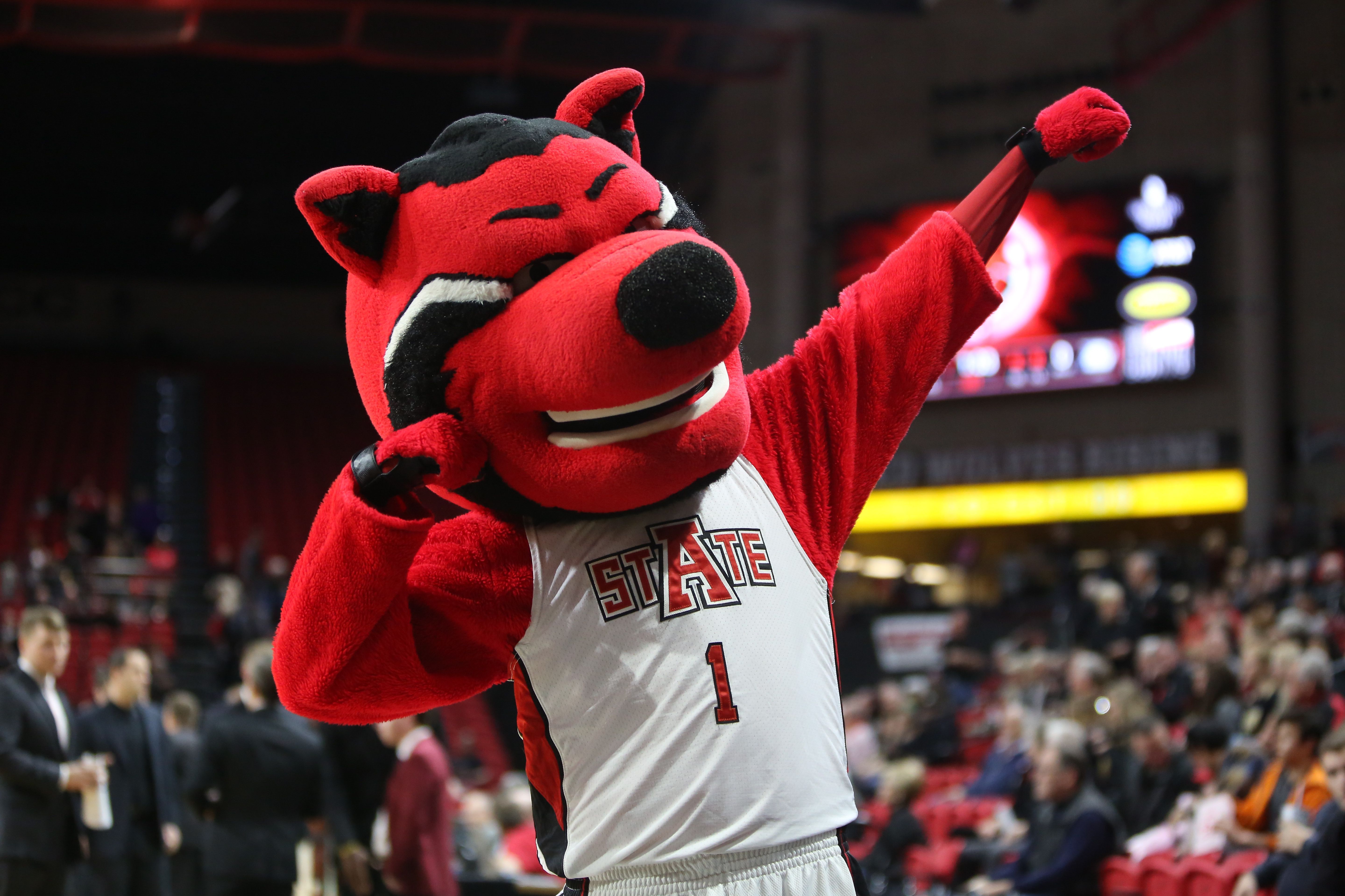Photo of a mascot cheering on at a basketball game.