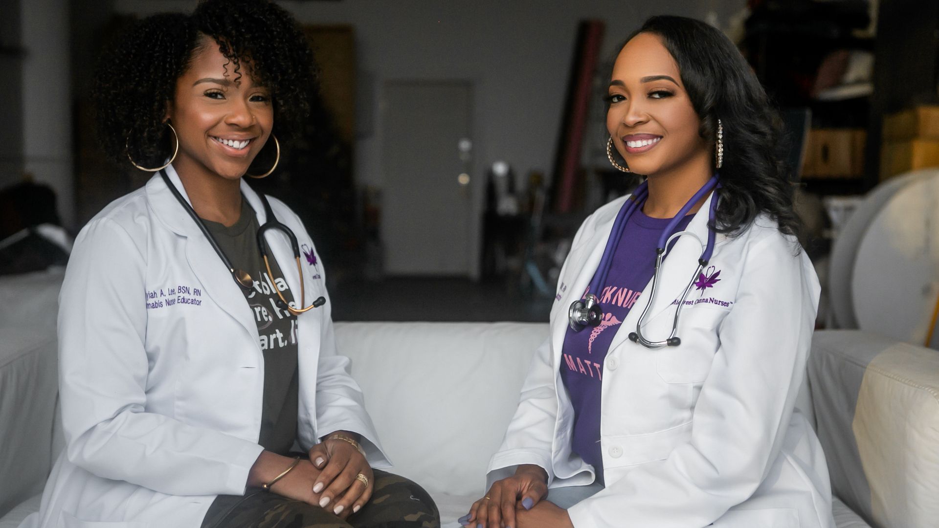 The two founders of Midwest CannaNurses sit in their white coats