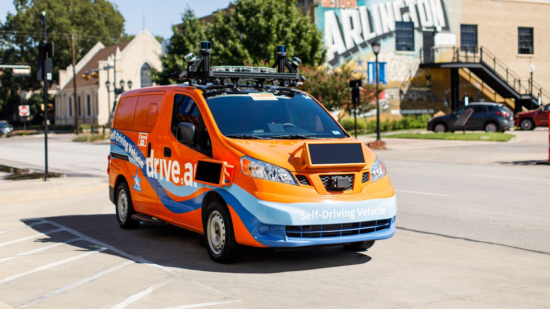 Image of orange Drive.ai autonomous van on the streets of Arlington, Texas
