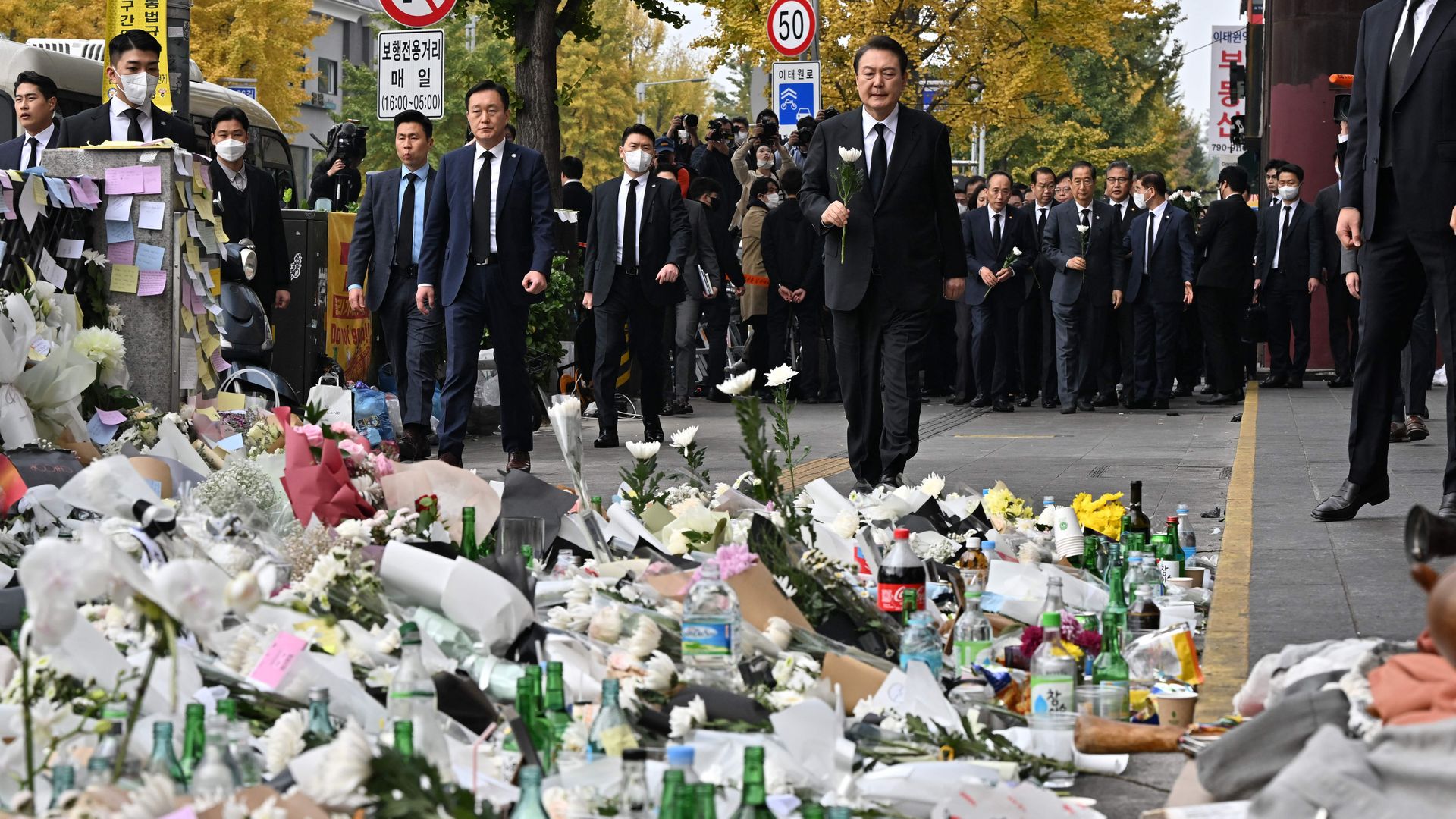 South Korean President Yoon Suk-yeol lays a flower at a makeshift memorial 