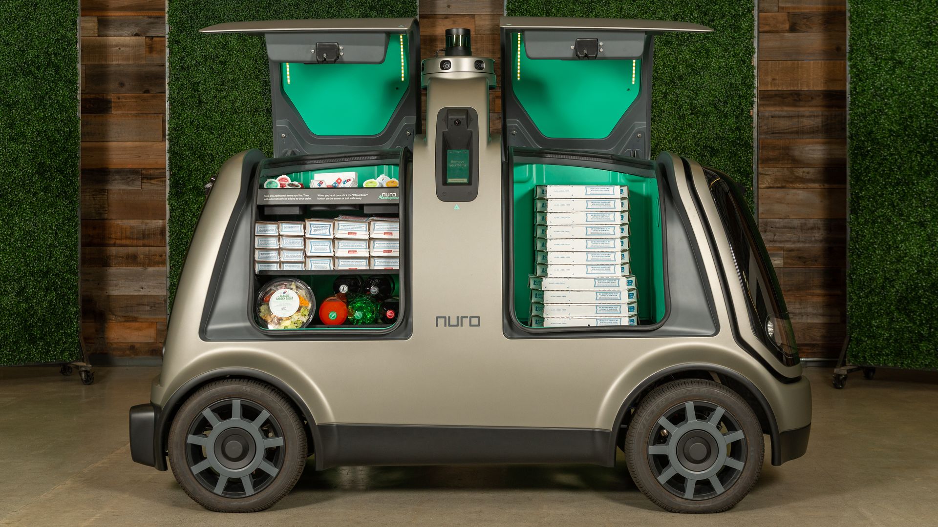 Nuro self driving vehicle with Domino's pizzas in it