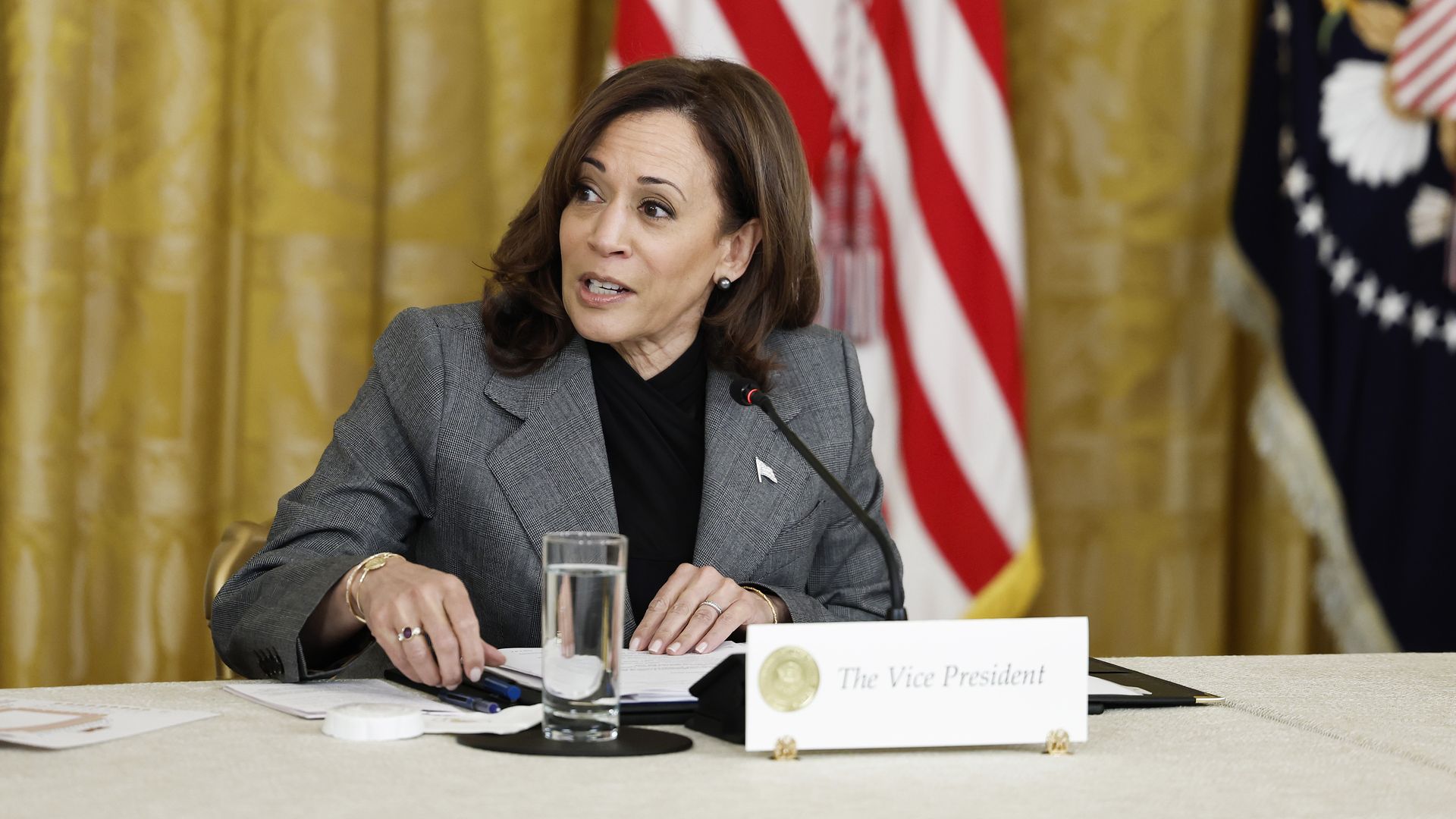 Picture of Kamala Harris sitting on a table with a sign that says "Vice President" in front of her