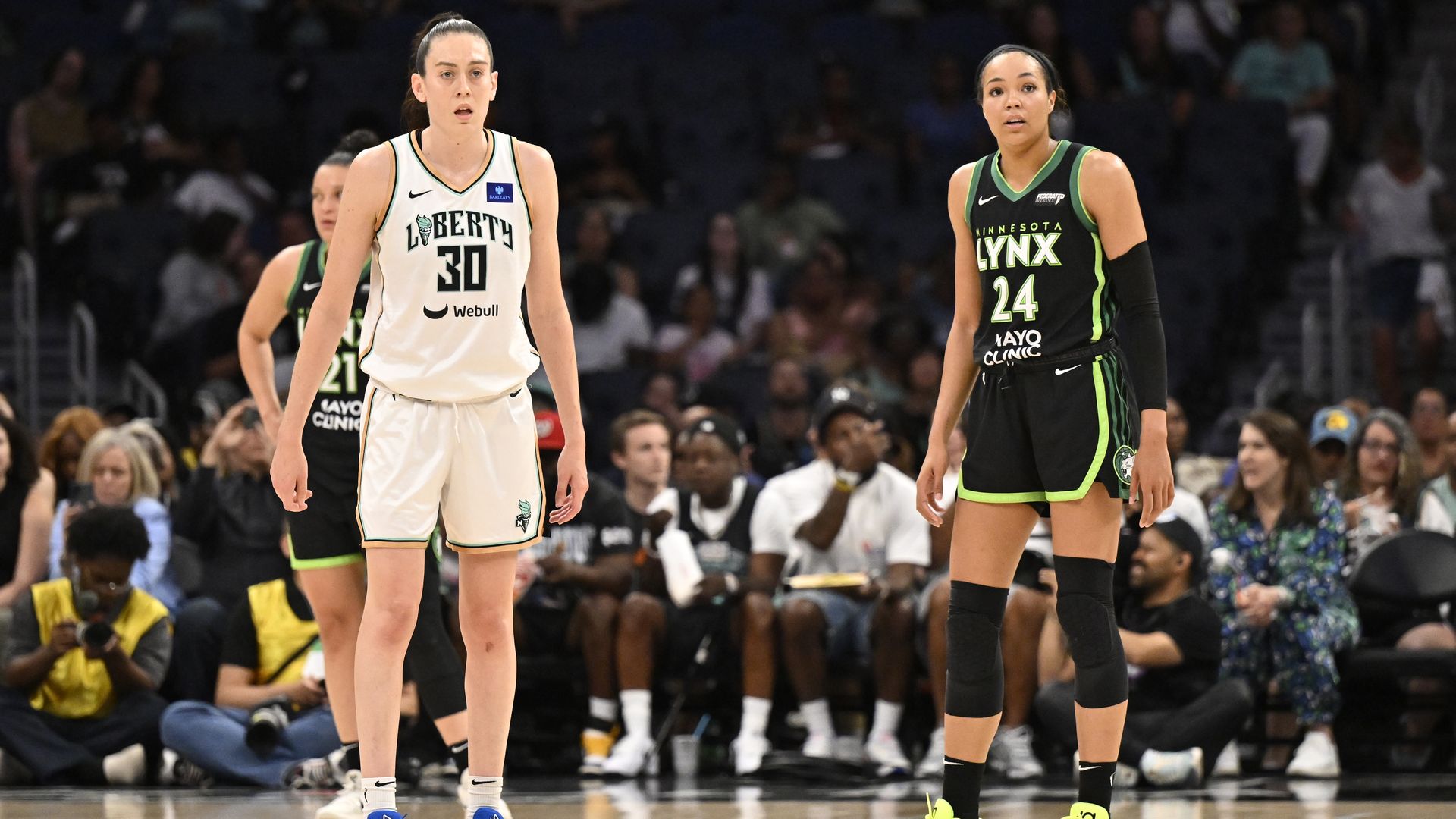 Breanna Steward and Napheesha Collier stand near each other on the court