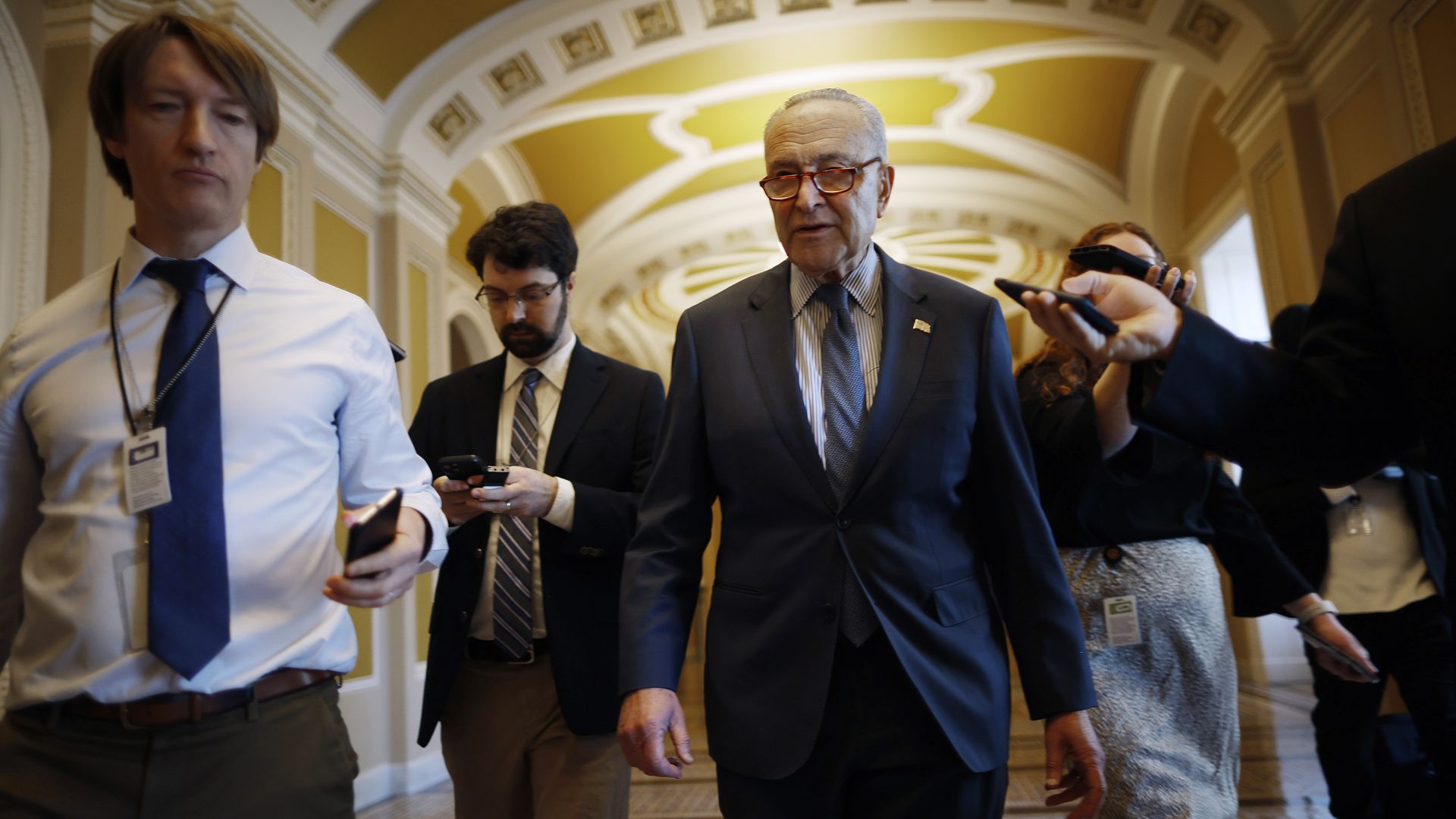 Senate Majority Leader Charles Schumer (D-NY) talks to reporters as he walks to his office